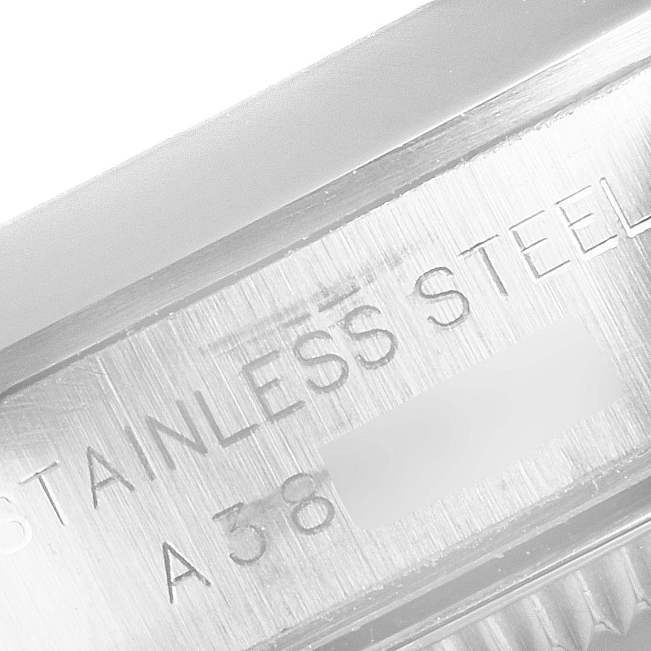 The image shows a close-up of the side engraving on a Rolex Oyster Perpetual 76080 Women
s Stainless Steel Black Dial 76080 Women
s Stainless Steel Black Dial watch, highlighting the "STAINLESS STEEL" text.