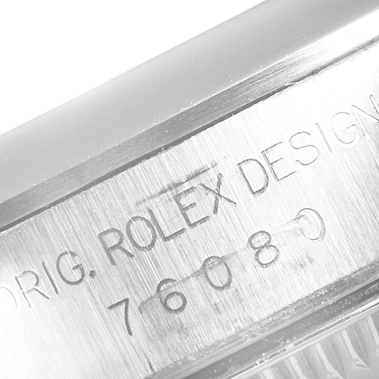 This image shows a close-up of the case side with engraved text of a Rolex Oyster Perpetual 76080 Women
s Stainless Steel Black Dial 76080 Women
s Stainless Steel Black Dial watch.