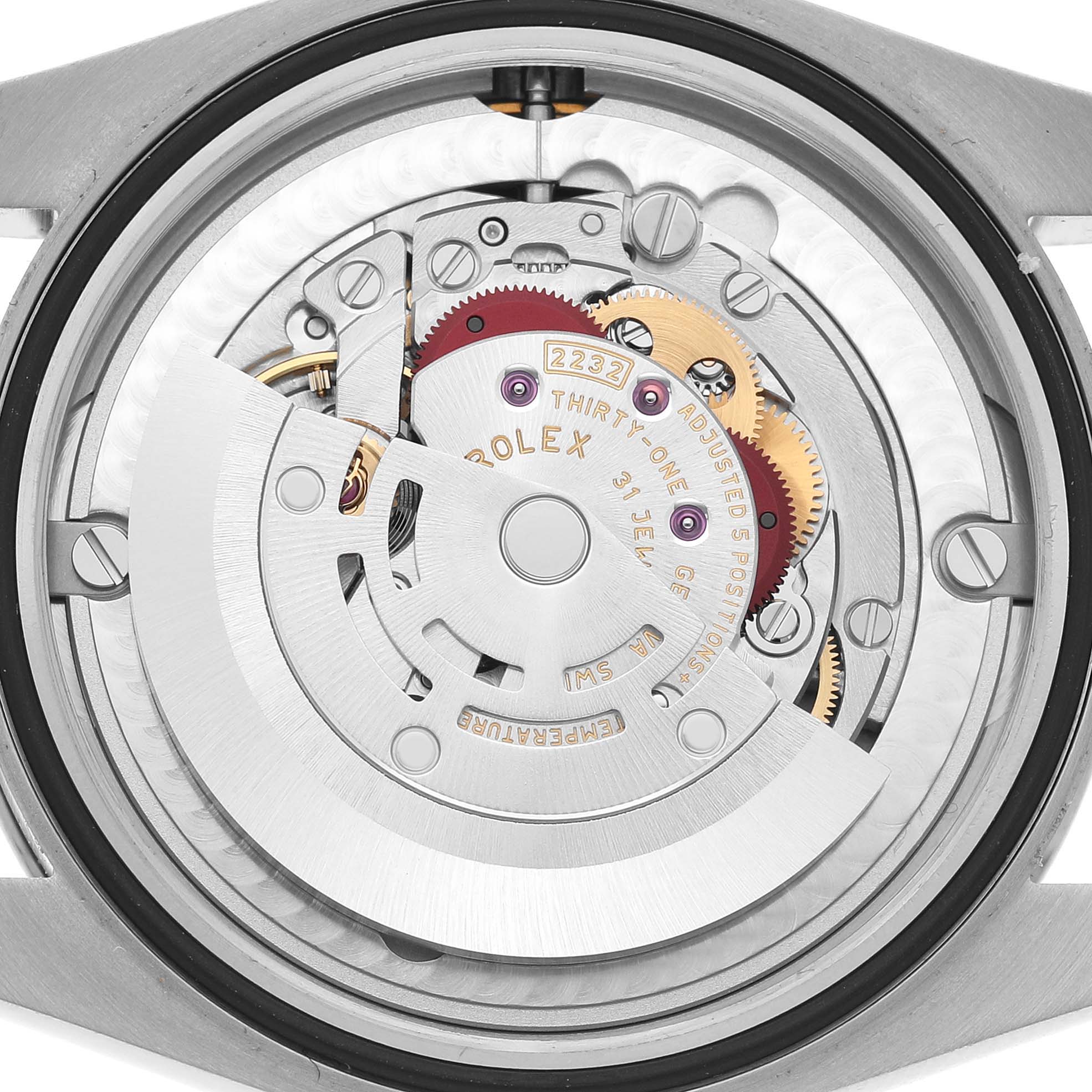 The image shows the internal mechanism of a Rolex Oyster Perpetual 124200 Men's Stainless Steel Green Dial, viewed from the back, highlighting gears and the rotor.