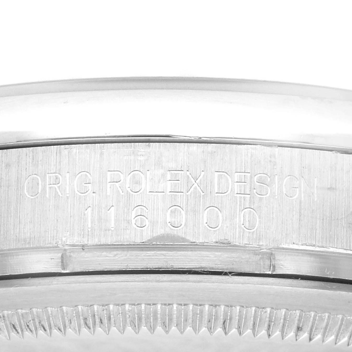 The image shows a close-up of the edge of a Rolex Oyster Perpetual 116000 Men's Stainless Steel Silver Dial 116000 Men's Stainless Steel Silver Dial watch case, featuring the inscription "ORIG. ROLEX DESIGN 116000."