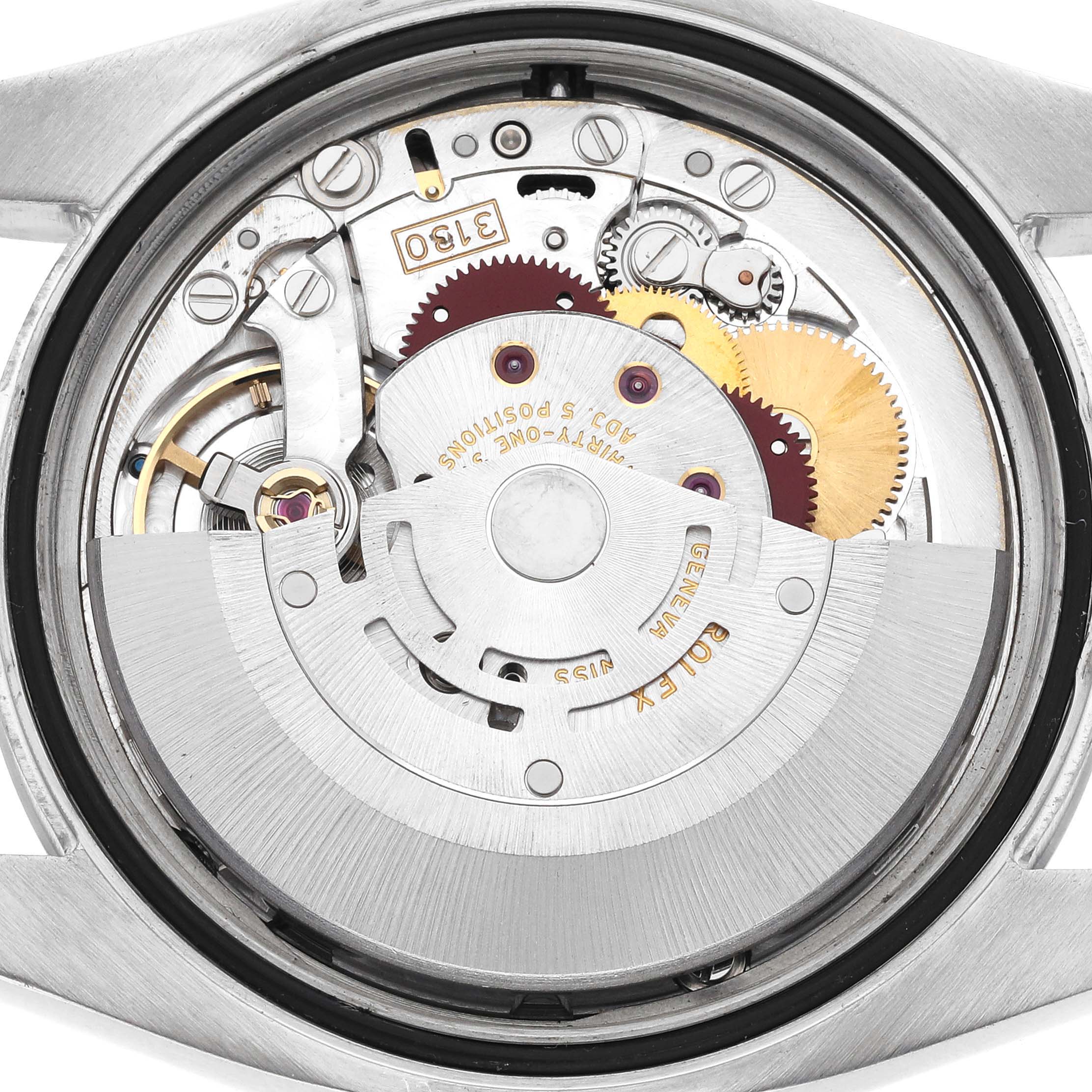 The image shows the movement mechanism of a Rolex Oyster Perpetual 116000 Men's Stainless Steel Silver Dial 116000 Men's Stainless Steel Silver Dial watch from a rear angle.