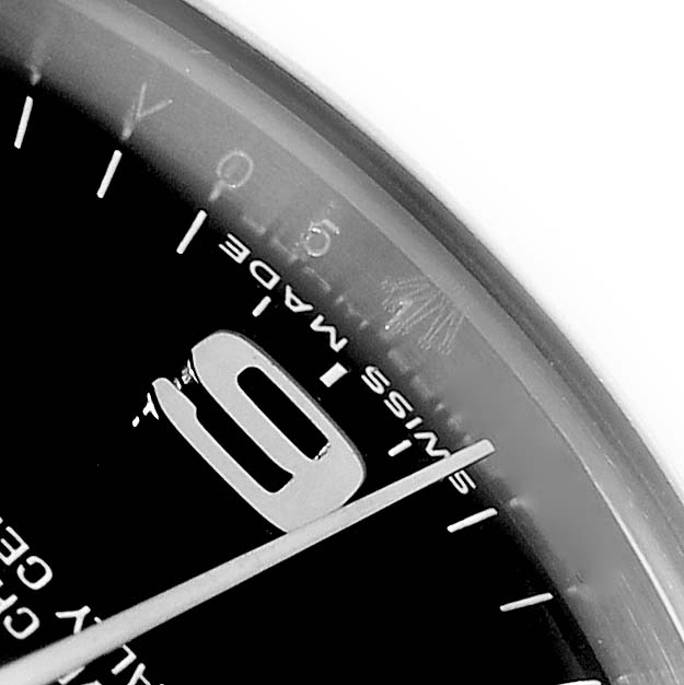 This close-up angle of the Rolex Mid-Size 177234 Women
s Stainless Steel Black Dial watch shows a partial view of the dial, the "6" numeral, markers, and "SWISS MADE."