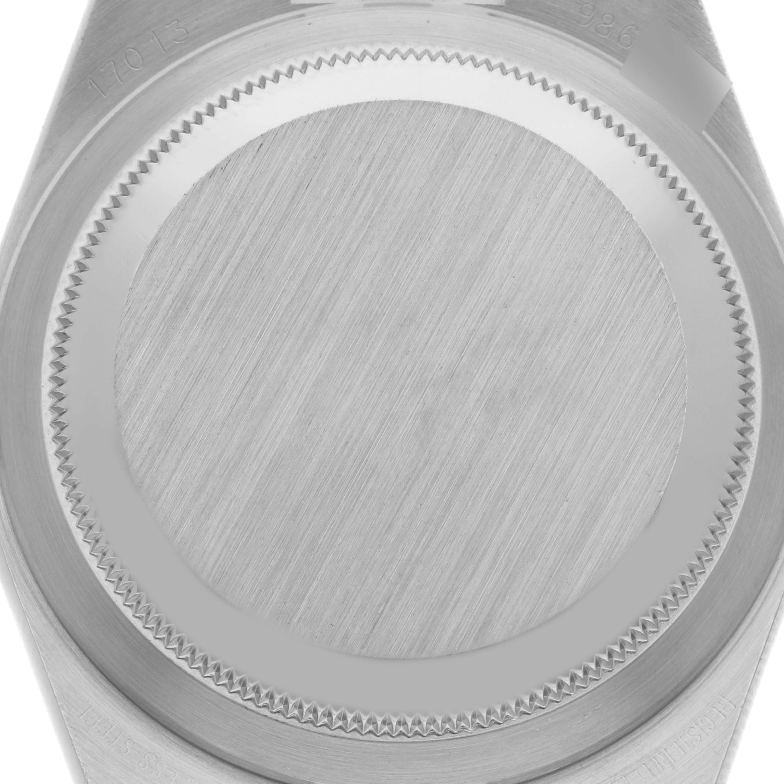 This image shows the back case of the Rolex Oysterquartz 17013 Men
s Steel and Gold (two tone) Black Dial 17013 Men
s Steel and Gold (two tone) Black Dial watch, viewed from a close-up angle, showcasing its brushed metal finish and serrated edges.