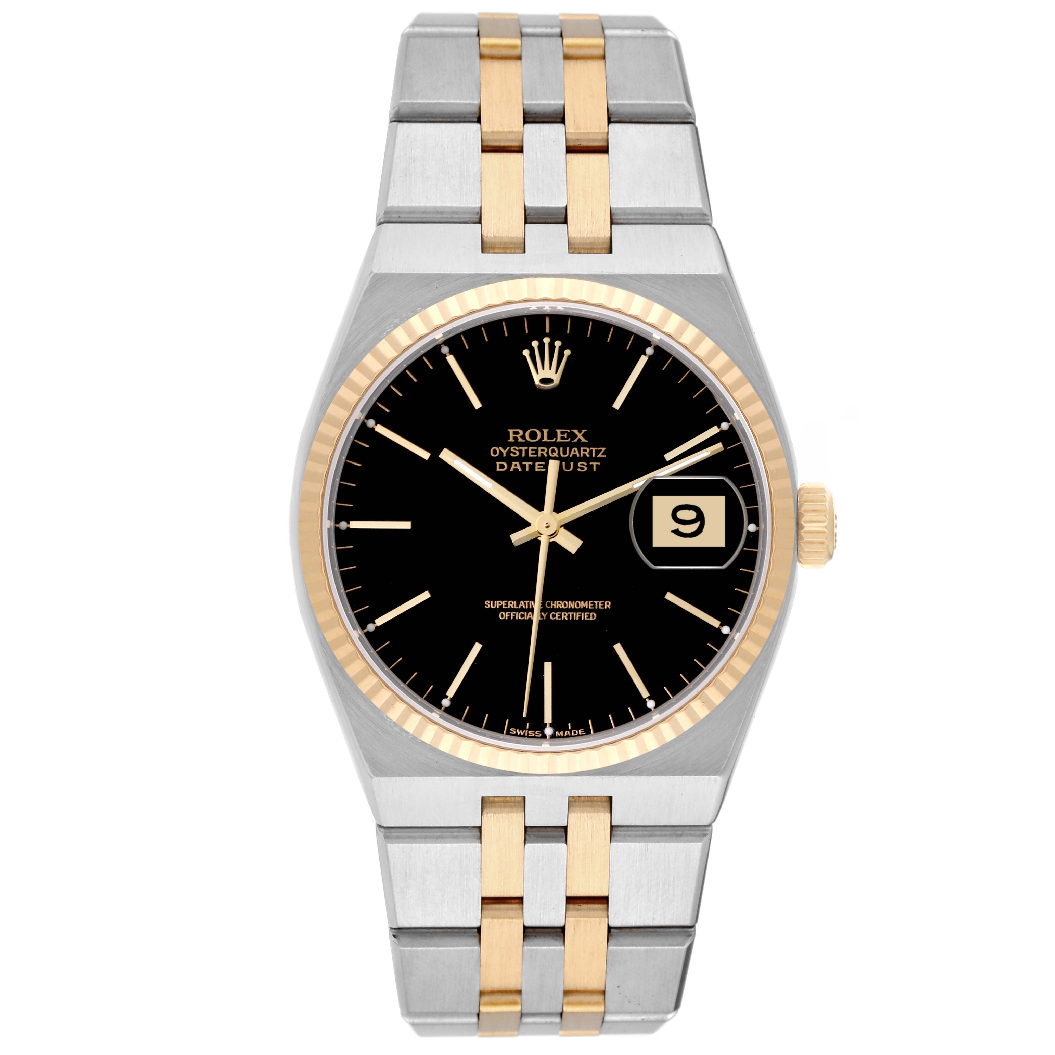 The image shows a Rolex Oysterquartz 17013 Men
s Steel and Gold (two tone) Black Dial 17013 Men
s Steel and Gold (two tone) Black Dial Datejust watch from a top-down angle, featuring a black dial and a two-tone metal bracelet.