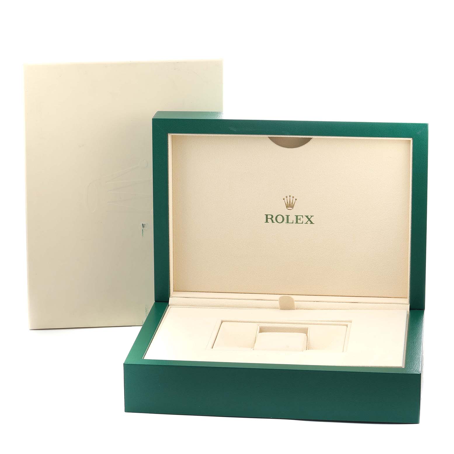 The image shows an open green and cream Rolex box for the President model, viewed from the front.