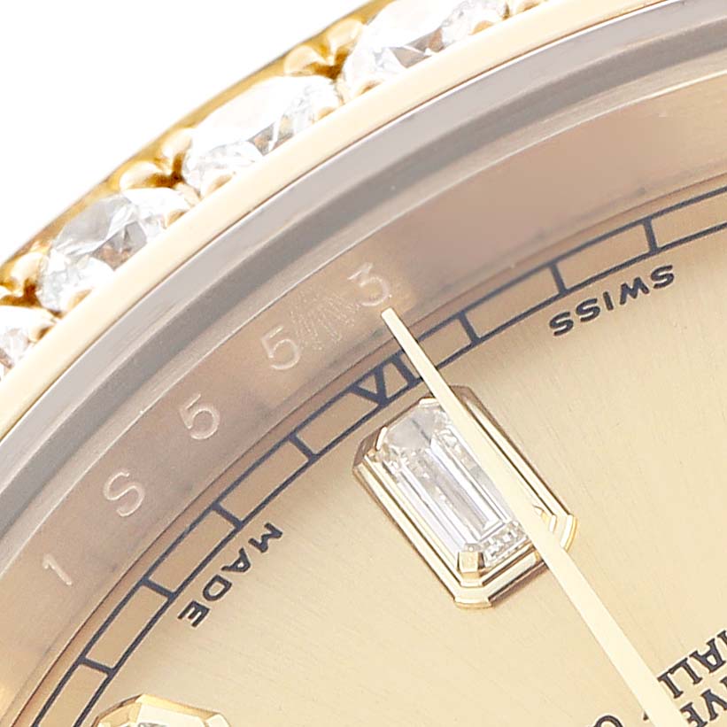 The image shows a close-up of the Rolex President 218348 Men
s Yellow Gold Champagne Dial watch, featuring part of the dial, a diamond-set bezel, and the hands.