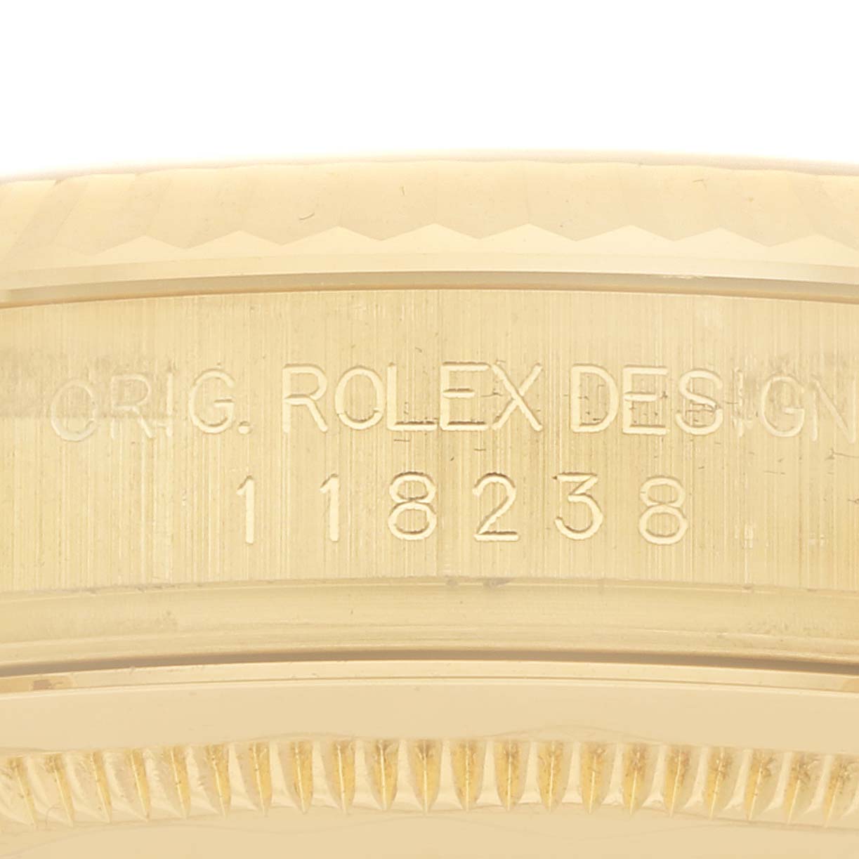 The image shows a close-up of the case serial engraving on a Rolex President 118238 Men
s Yellow Gold Champagne Dial model, highlighting the model number.