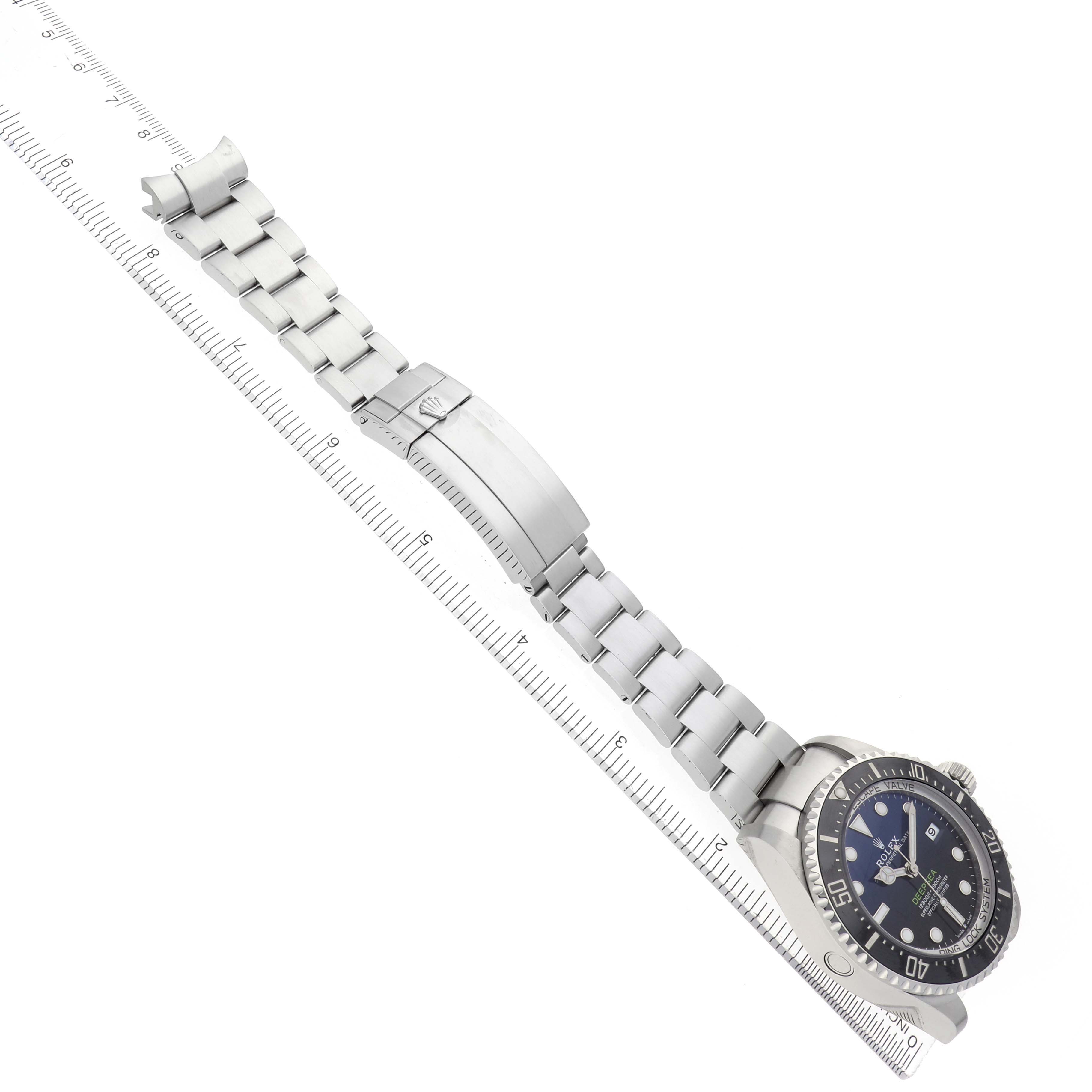 The Rolex Sea-Dweller 136660 Men
s Stainless Steel Blue Dial watch is shown at an angled side view, displaying the bracelet, clasp, and face.