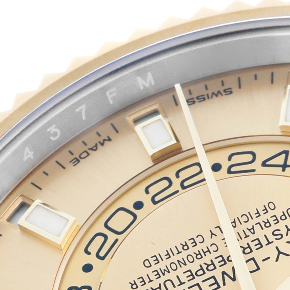 The image shows a close-up of the Rolex Sky-Dweller 3269333 Men
s Steel and Gold (two tone) Champagne Dial
s dial, focusing on the hour markers, hand, and part of the 24-hour disc.