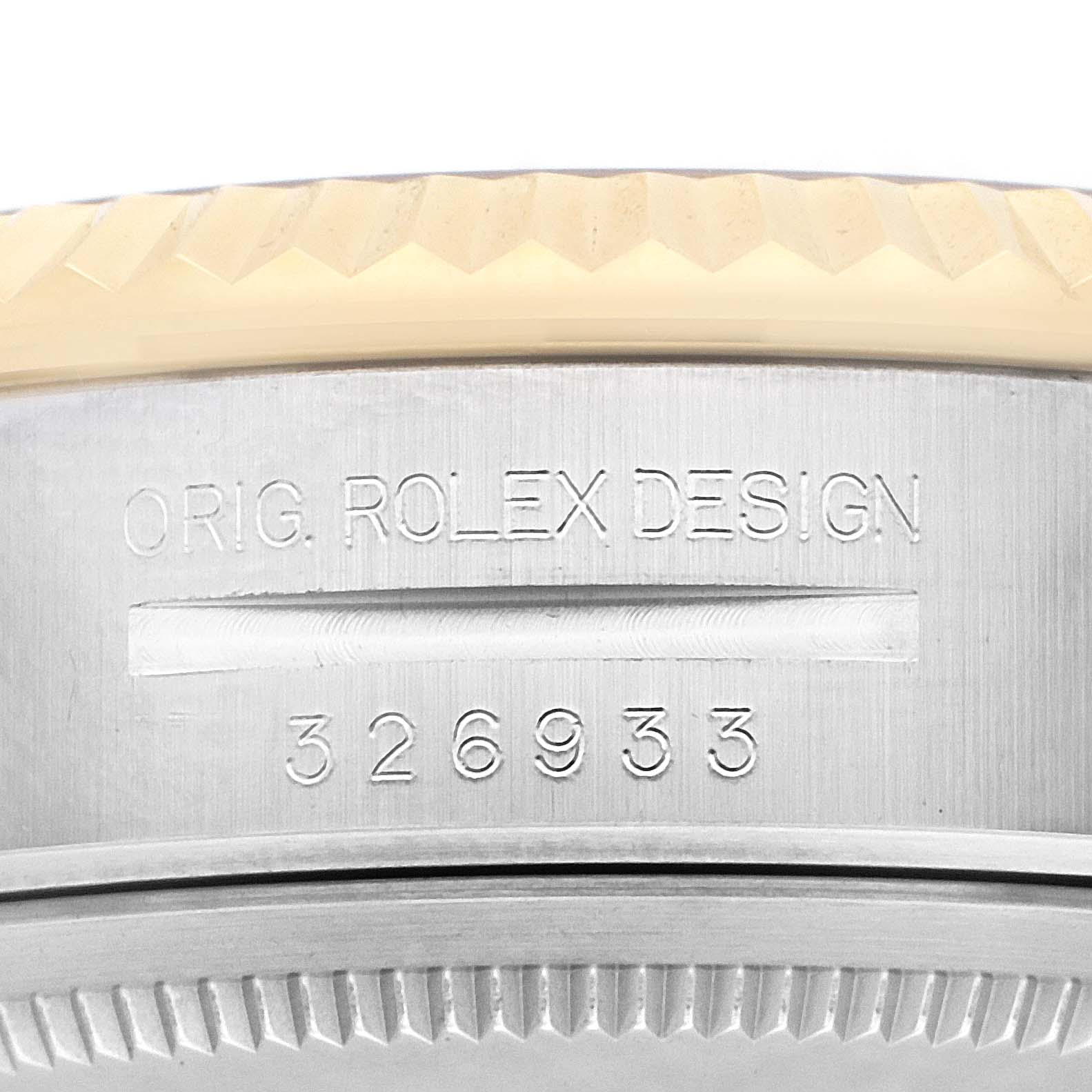 The image shows a close-up of the case side of a Rolex Sky-Dweller 3269333 Men
s Steel and Gold (two tone) Champagne Dial, highlighting the engraving and serrated bezel edge.