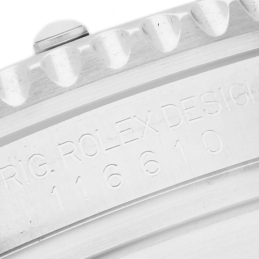 The image shows a close-up of the bezel edge and engraved side of a Rolex Submariner 116610 Men
s Stainless Steel Green Dial watch.