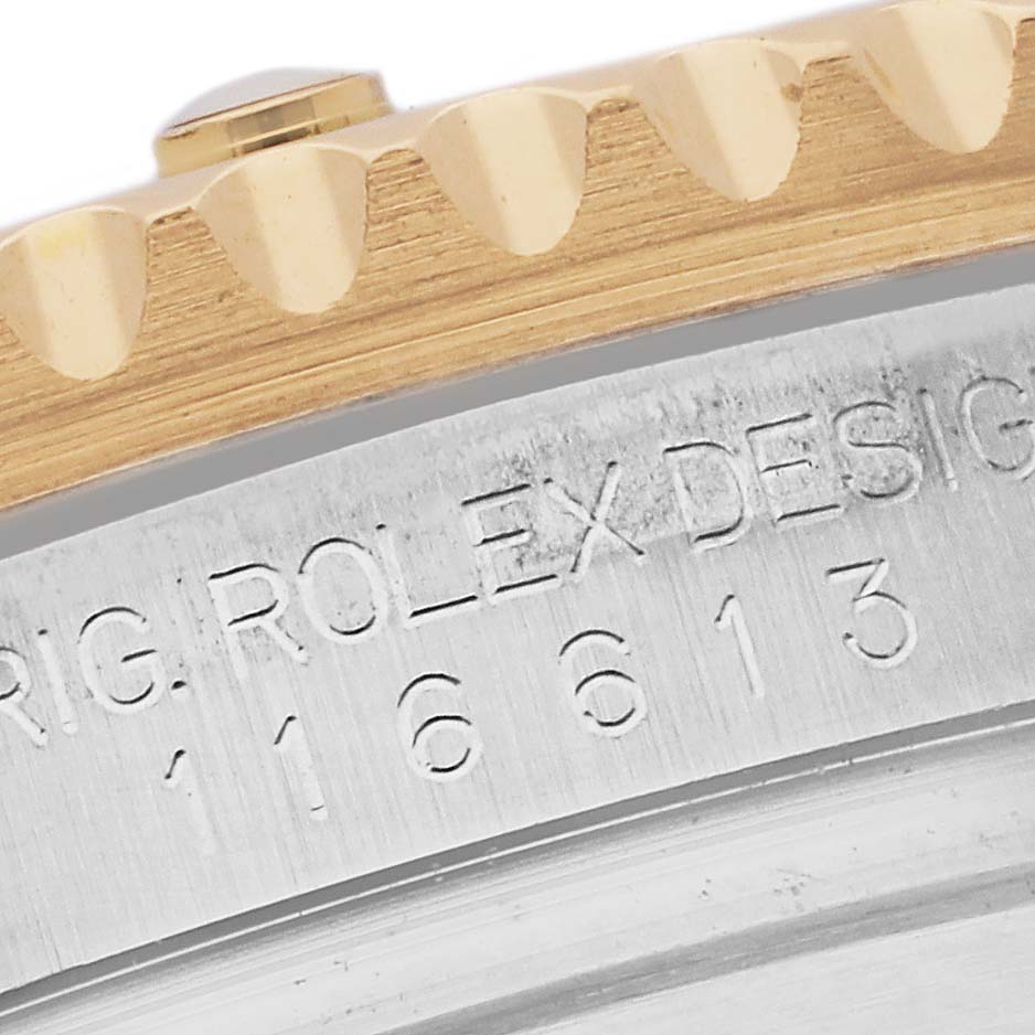 This close-up photo of the Rolex Submariner 116613 Men's Steel and Gold (two tone) Blue Dial 116613 Men's Steel and Gold (two tone) Blue Dial shows part of the bezel and the engraved reference number on the case.