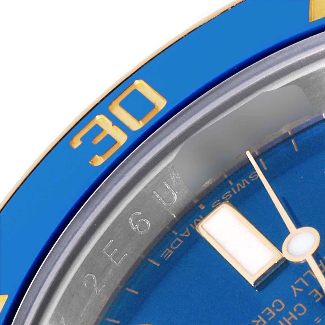 The image shows a close-up of the bezel, dial, and part of the minute hand of a Rolex Submariner 116613 Men's Steel and Gold (two tone) Blue Dial 116613 Men's Steel and Gold (two tone) Blue Dial watch.