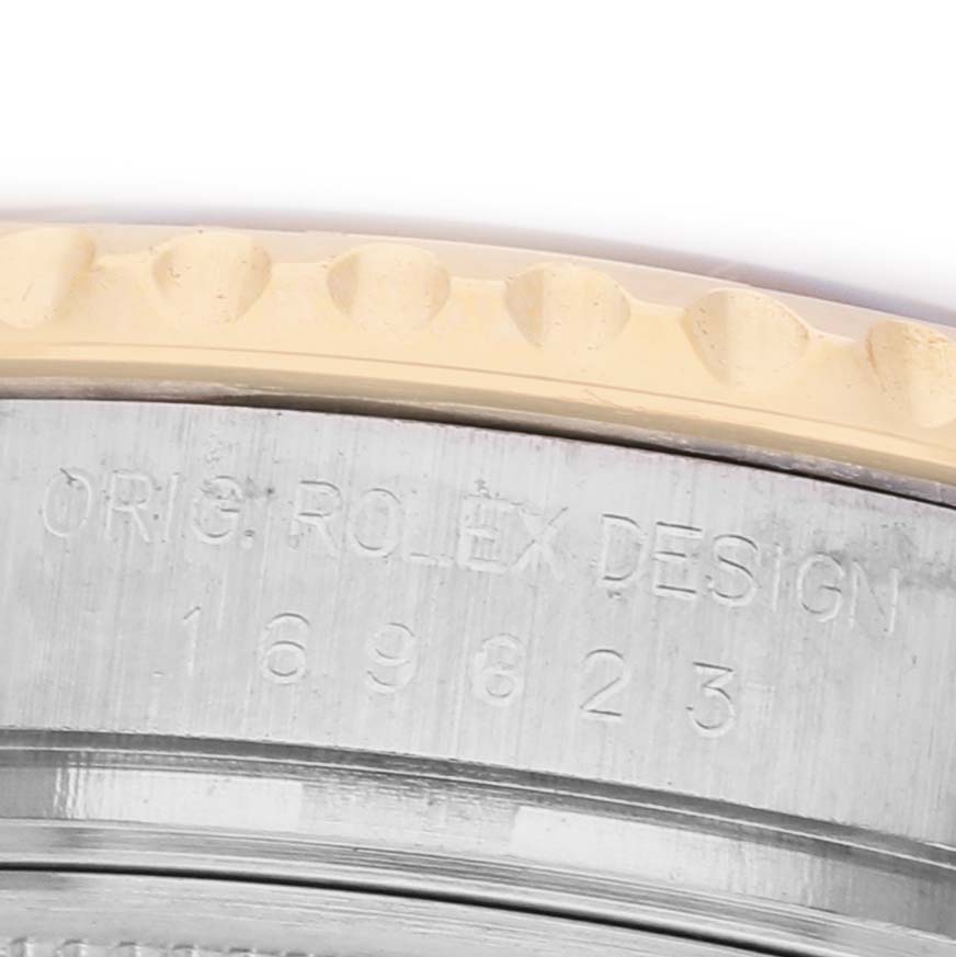 The image shows a close-up of the case side of a Rolex Yacht-Master 169623 Women's Steel and Gold (two tone) White Dial, focusing on the engraved text.