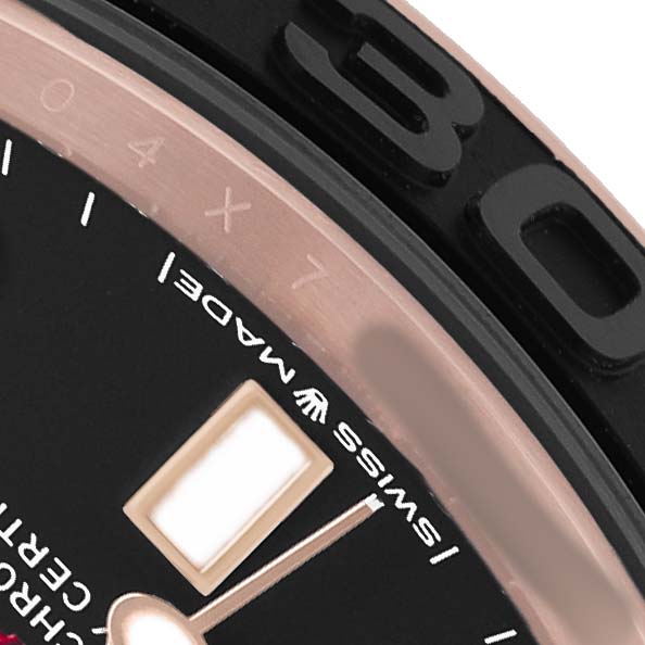 The image shows a close-up of the Rolex Yacht-Master 268655 Men's Rose Gold Black Dial's bezel, part of the dial, and an hour marker.