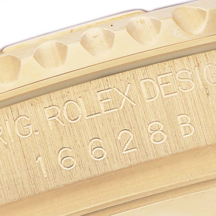 This close-up image shows the engraved case back and bezel of a Rolex Yacht-Master 16628 Men's Yellow Gold Blue Dial 16628 Men's Yellow Gold Blue Dial watch.