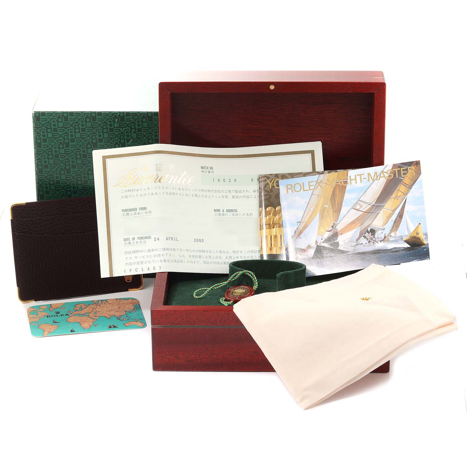 The image shows a complete set of accessories for the Rolex Yacht-Master 16628 Men's Yellow Gold Blue Dial 16628 Men's Yellow Gold Blue Dial, including the box, papers, booklet, and tag.