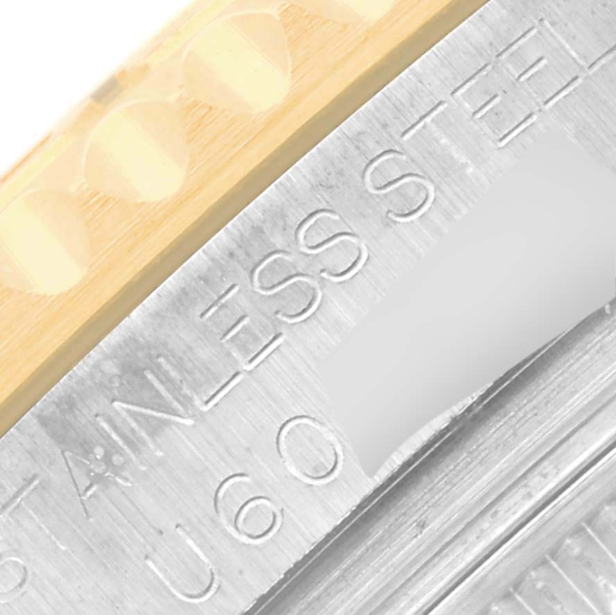 This close-up shows the stainless steel and gold outer edge, bezel, and part of the inscription on the Rolex Yacht-Master 68623 Men's Steel and Gold (two tone) White Dial 68623 Men's Steel and Gold (two tone) White Dial watch.