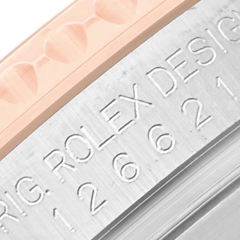 Close-up of the bezel and part of the casing of the Rolex Yacht-Master 126621 Men's Steel and Gold (two tone) Brown Dial 126621 Men's Steel and Gold (two tone) Brown Dial watch, showing its textured and engraved details.