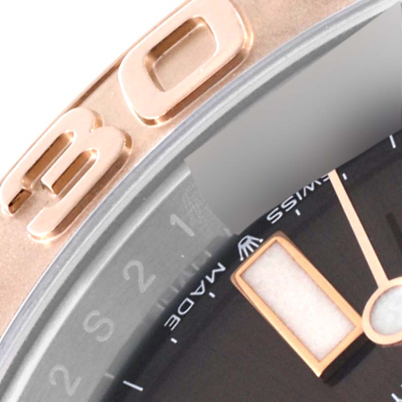The image shows a close-up angle of the dial and bezel of a Rolex Yacht-Master 126621 Men's Steel and Gold (two tone) Brown Dial 126621 Men's Steel and Gold (two tone) Brown Dial watch, highlighting the hour hand and part of the "30" on the bezel.