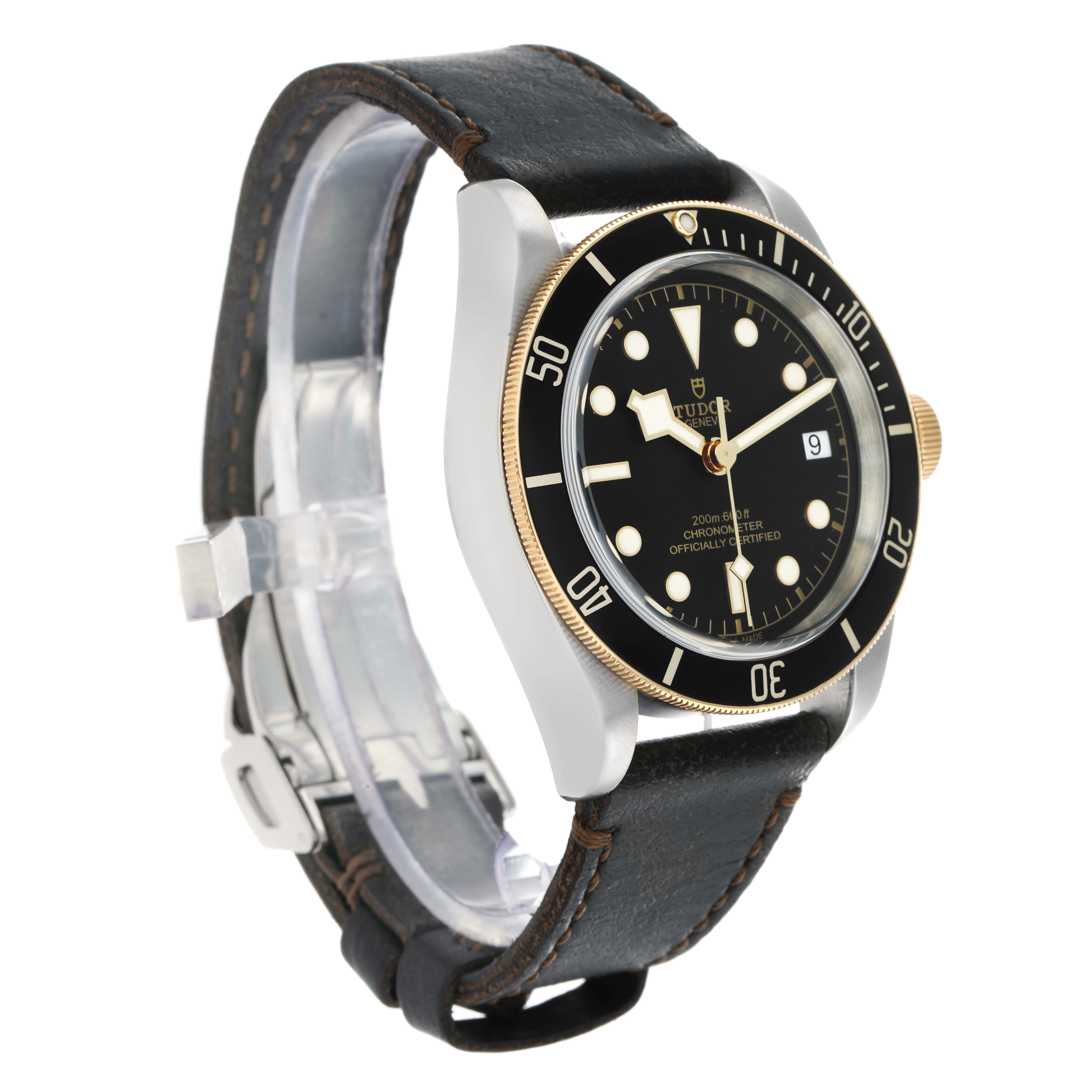 The Tudor Heritage Black Bay 79733 Men
s Steel and Gold (two tone) Black Dial watch is shown at a three-quarter angle, displaying the bezel, case, dial, and leather strap.