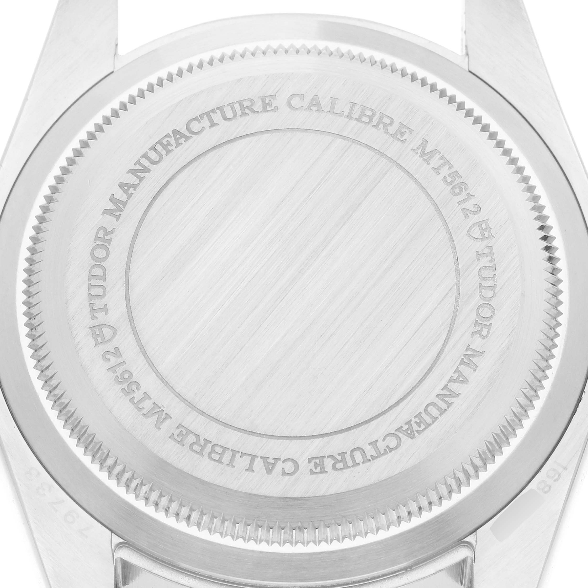 The image shows the case back of the Tudor Heritage Black Bay 79733 Men
s Steel and Gold (two tone) Black Dial watch, featuring engraved details.