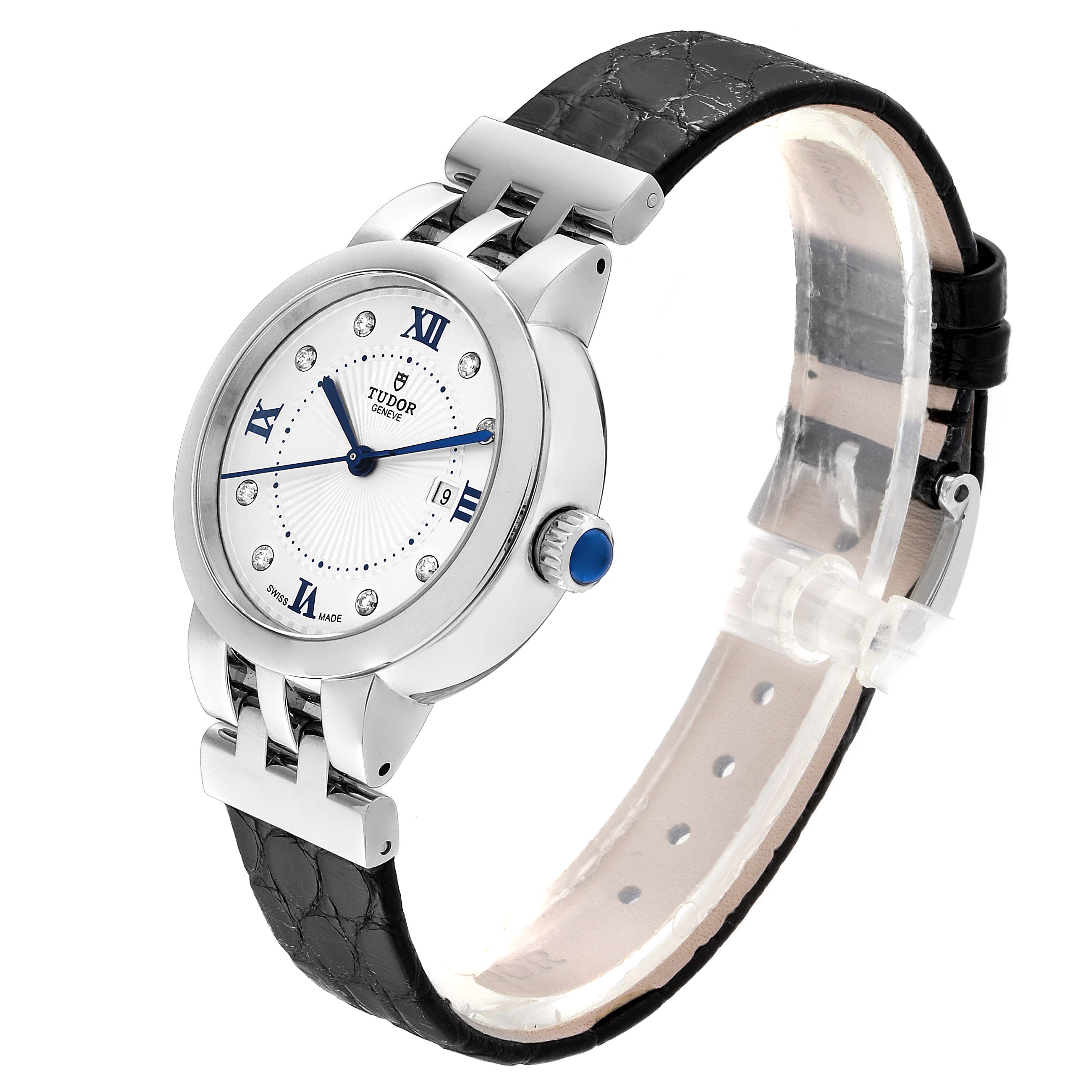 The image shows a Tudor Clair de Rose M35800-0006 Women
s Stainless Steel Silver Dial M35800-0006 Women
s Stainless Steel Silver Dial watch from an angled side view, highlighting its face, crown, and black leather strap.