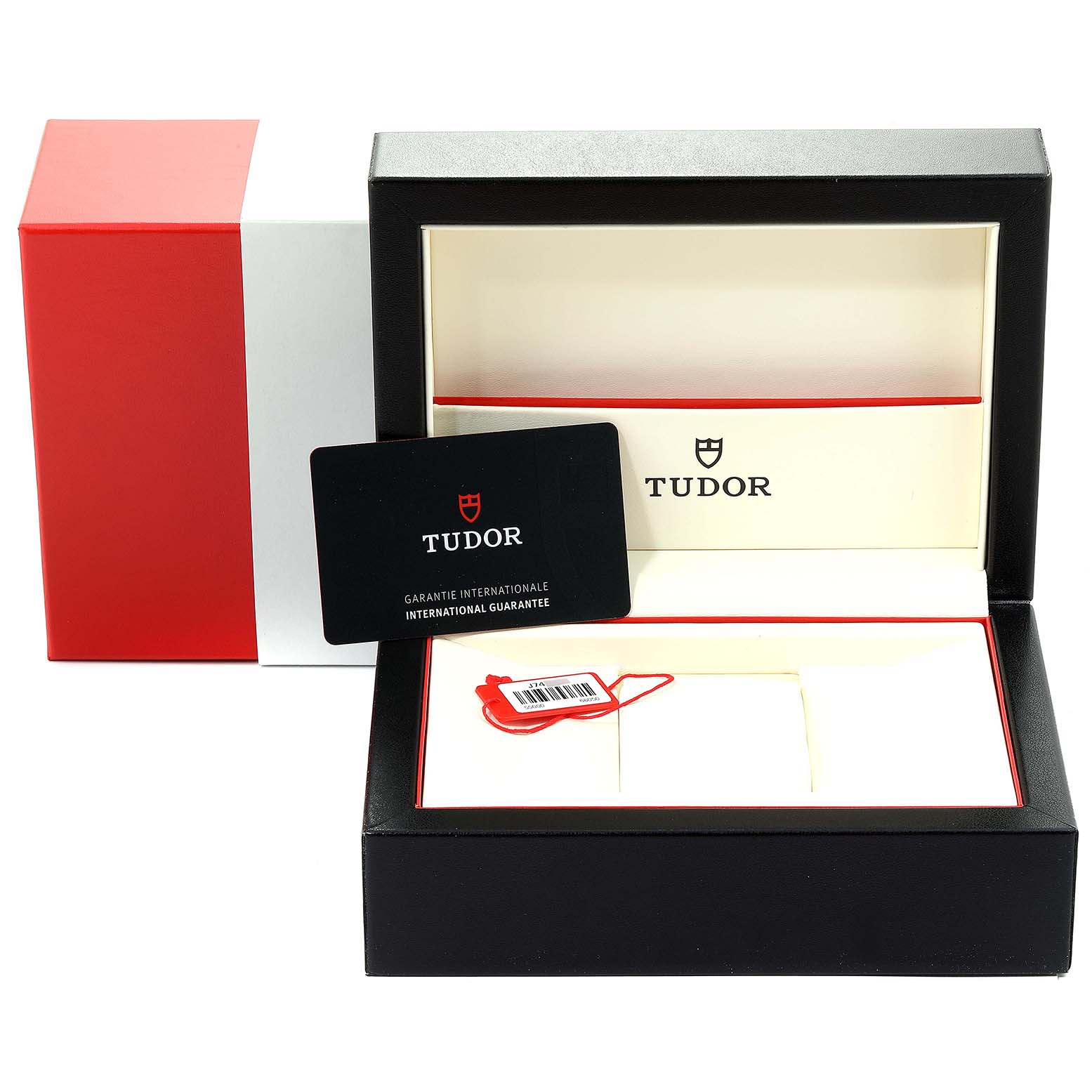 The image shows the packaging for a Tudor Glamour M55000-0007 Men's Stainless Steel Black Dial M55000-0007 Men's Stainless Steel Black Dial model watch, including the box, warranty card, and a tag.
