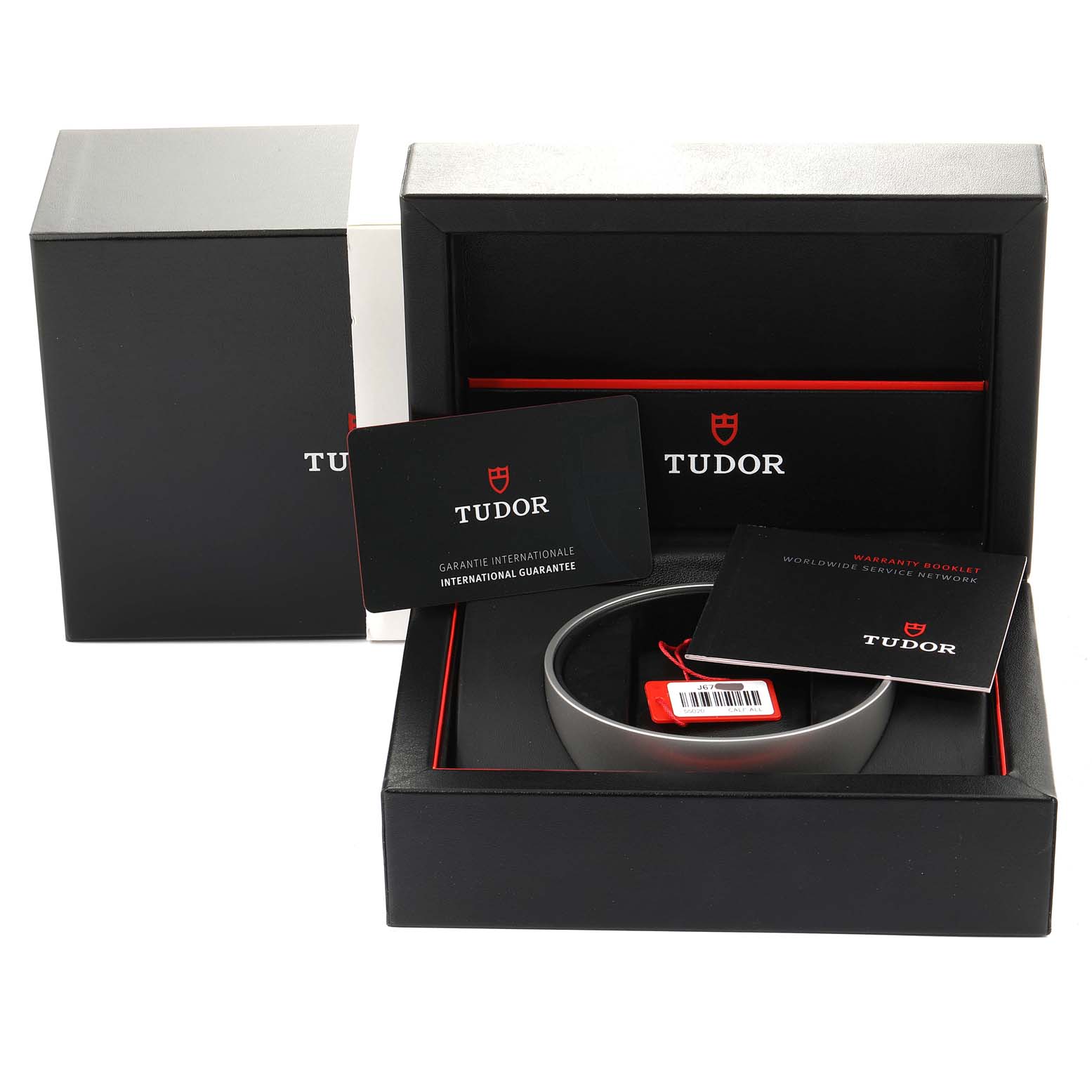 The image shows the packaging and accessories of the Tudor Glamour M55020-0057 Men's Stainless Steel Silver Dial M55020-0057 Men's Stainless Steel Silver Dial model, including a box, guarantee card, and warranty booklet.
