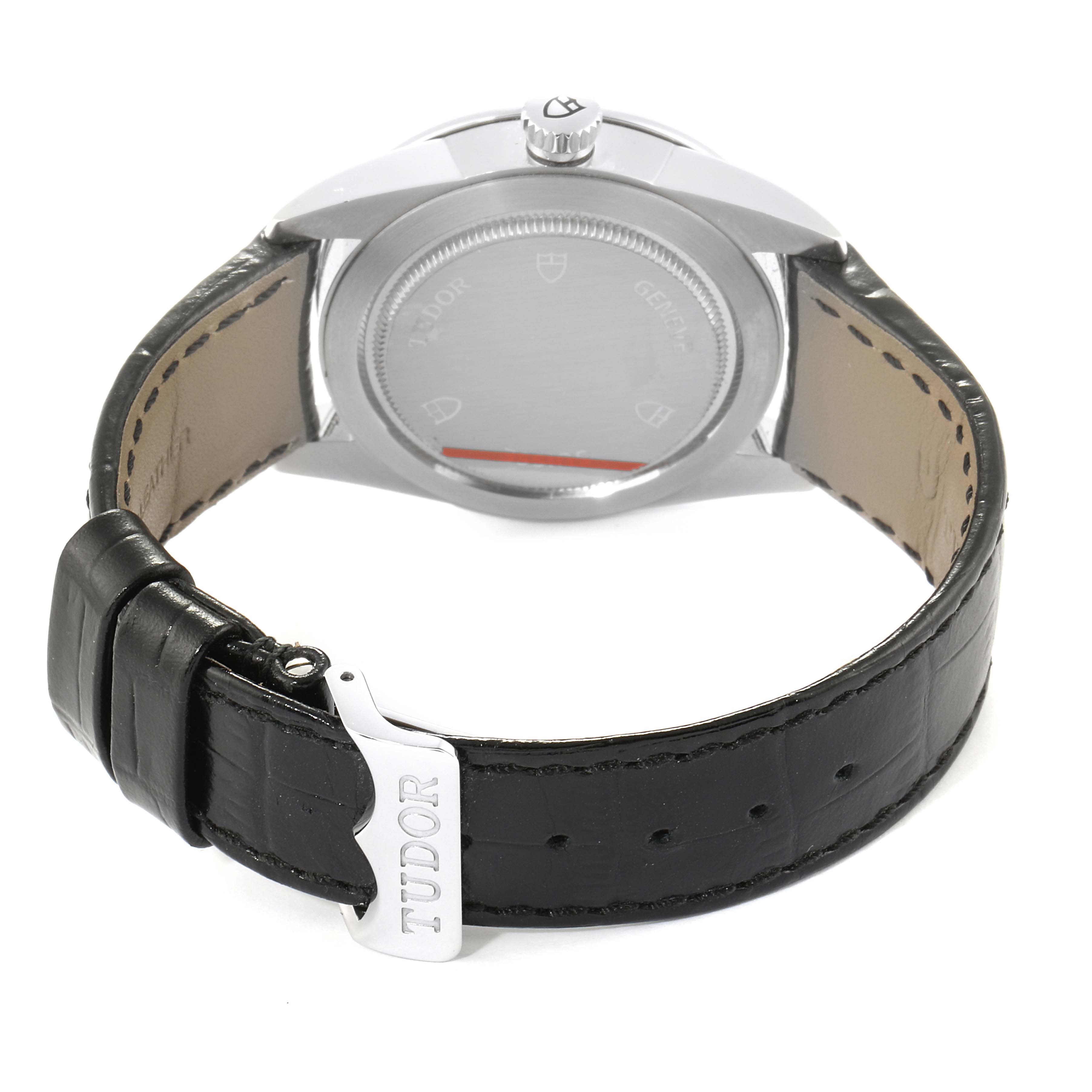 This is the back view of a Tudor Glamour M55020-0057 Men's Stainless Steel Silver Dial M55020-0057 Men's Stainless Steel Silver Dial watch, displaying the case back and leather strap with a clasp.