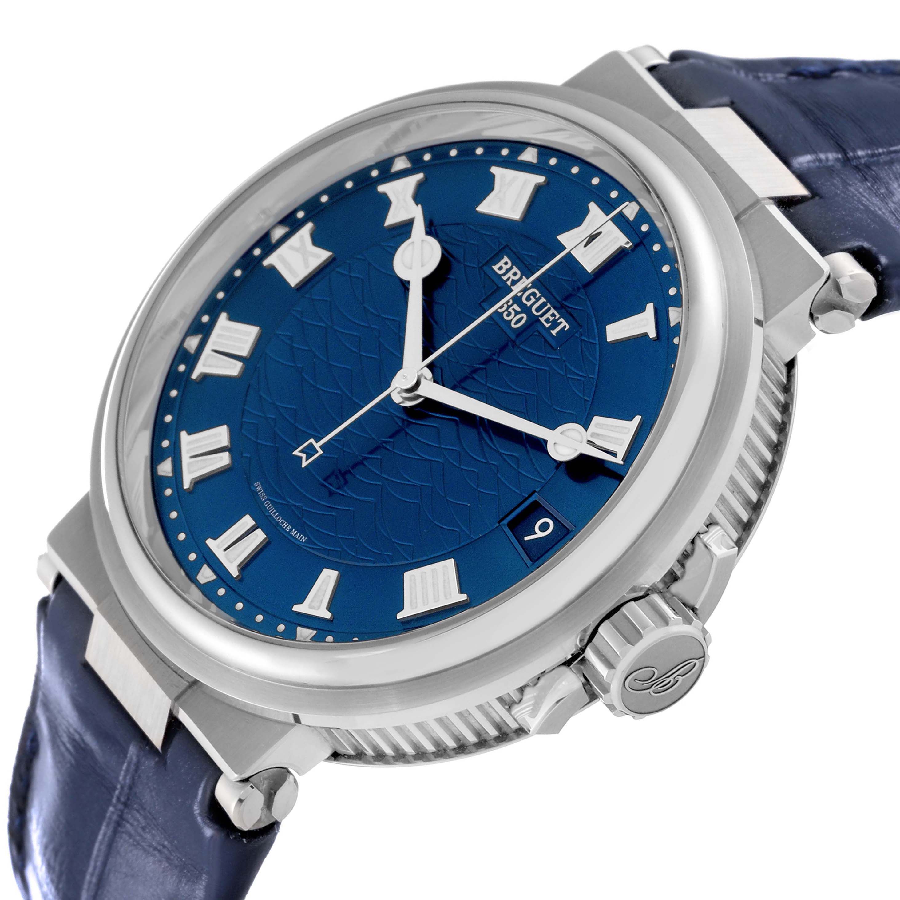 The image shows a Breguet Marine 5517BB/Y2/9ZU Men's White Gold Blue Dial 5517BB/Y2/9ZU Men's White Gold Blue Dial watch from a three-quarter angle, highlighting the blue dial, silver bezel, crown, and blue strap.