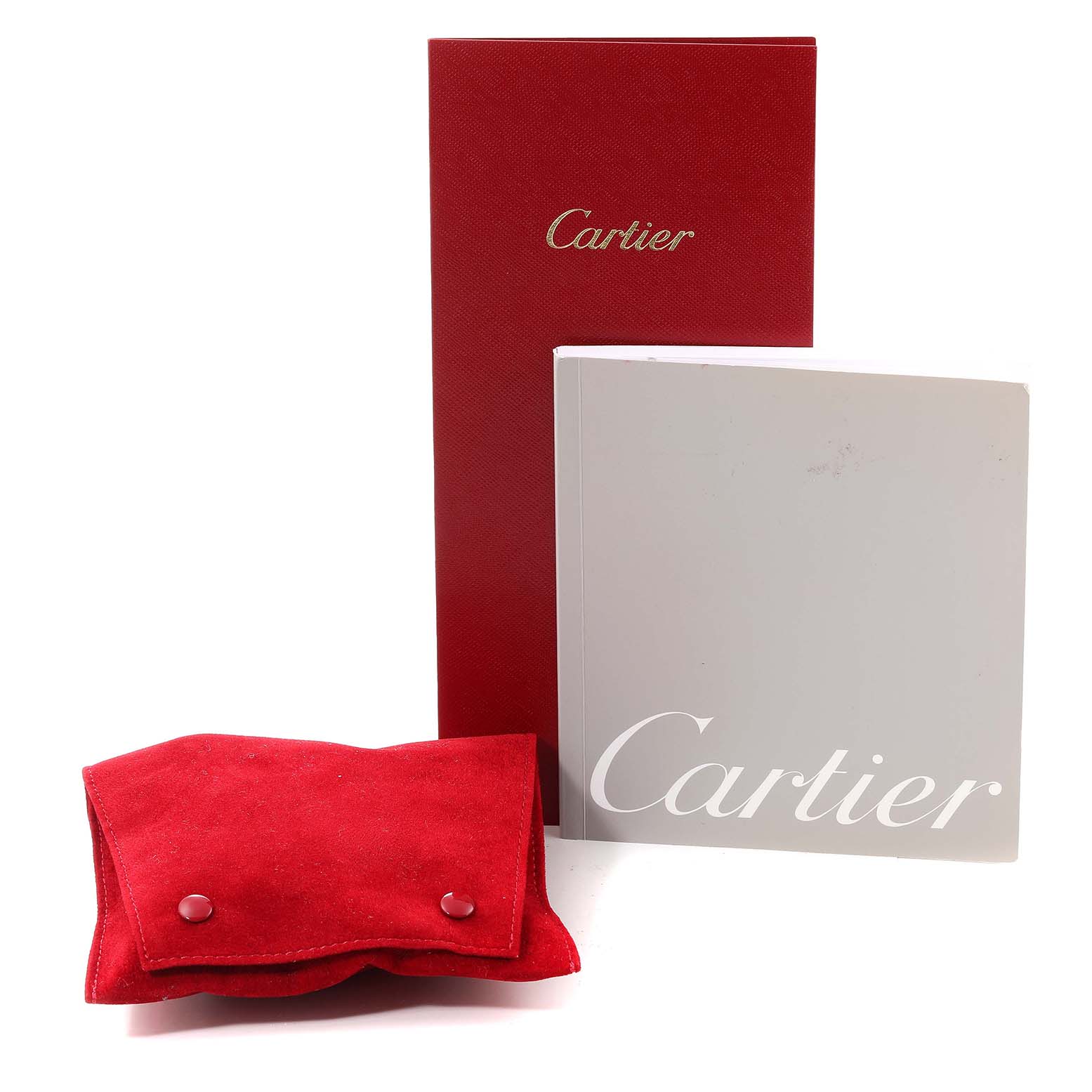 The image shows the packaging and accessories for the Cartier Santos Dumont W2007051 Men's White Gold Silver Dial W2007051 Men's White Gold Silver Dial model, including a red case, a red box, and a user manual.