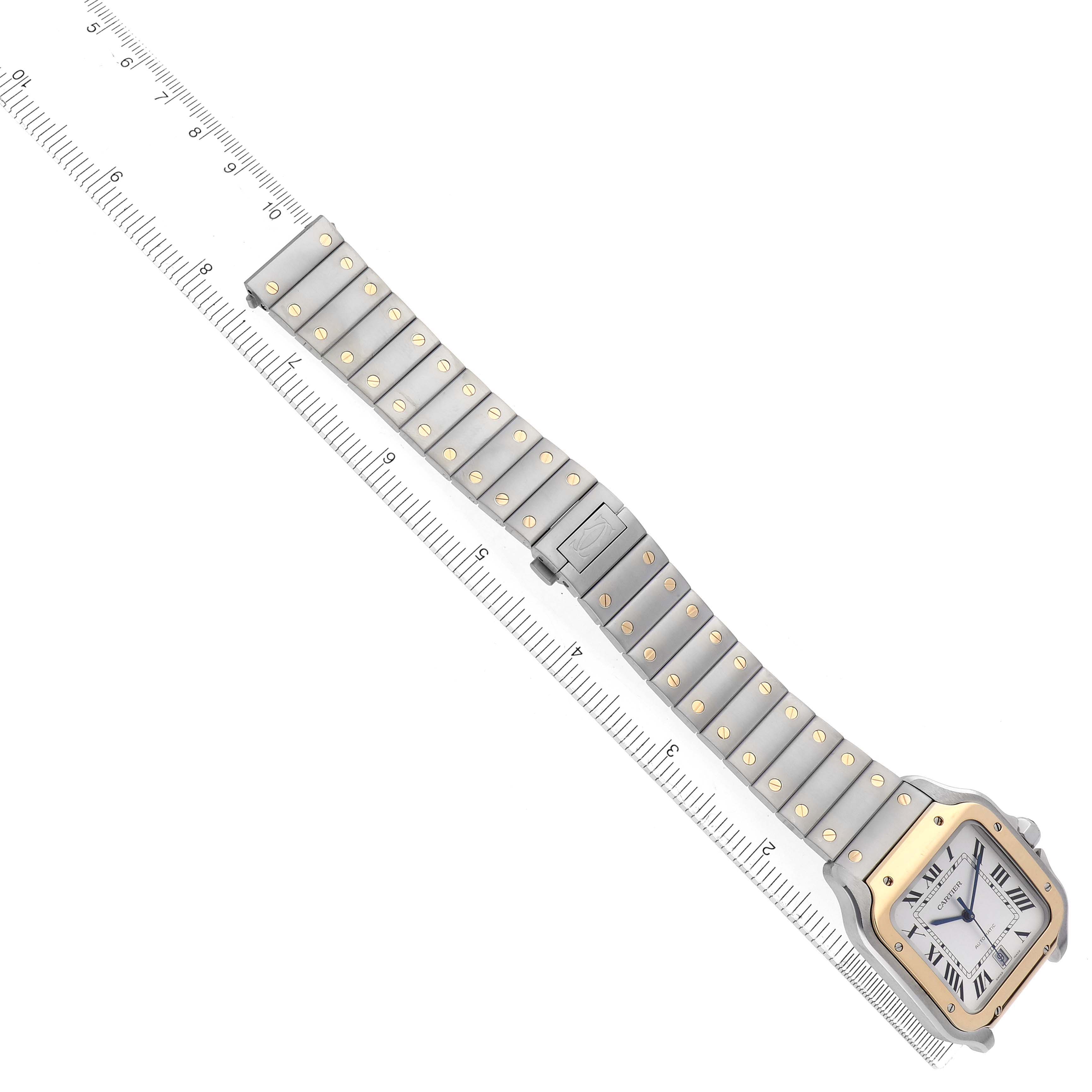 The image shows a Santos model by Cartier at an angle, highlighting the face, bezel, and bracelet with a ruler for scale.