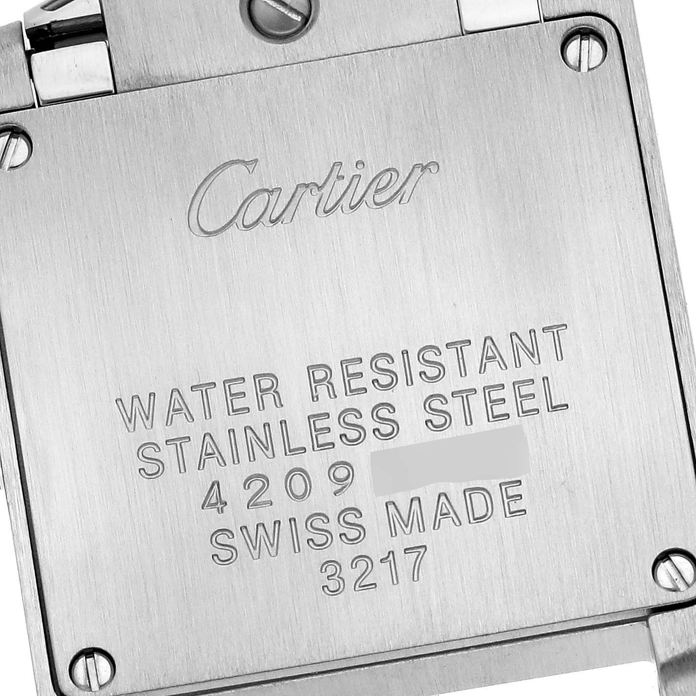 The image shows the case back of a Cartier Tank Française watch, displaying engravings and screws.