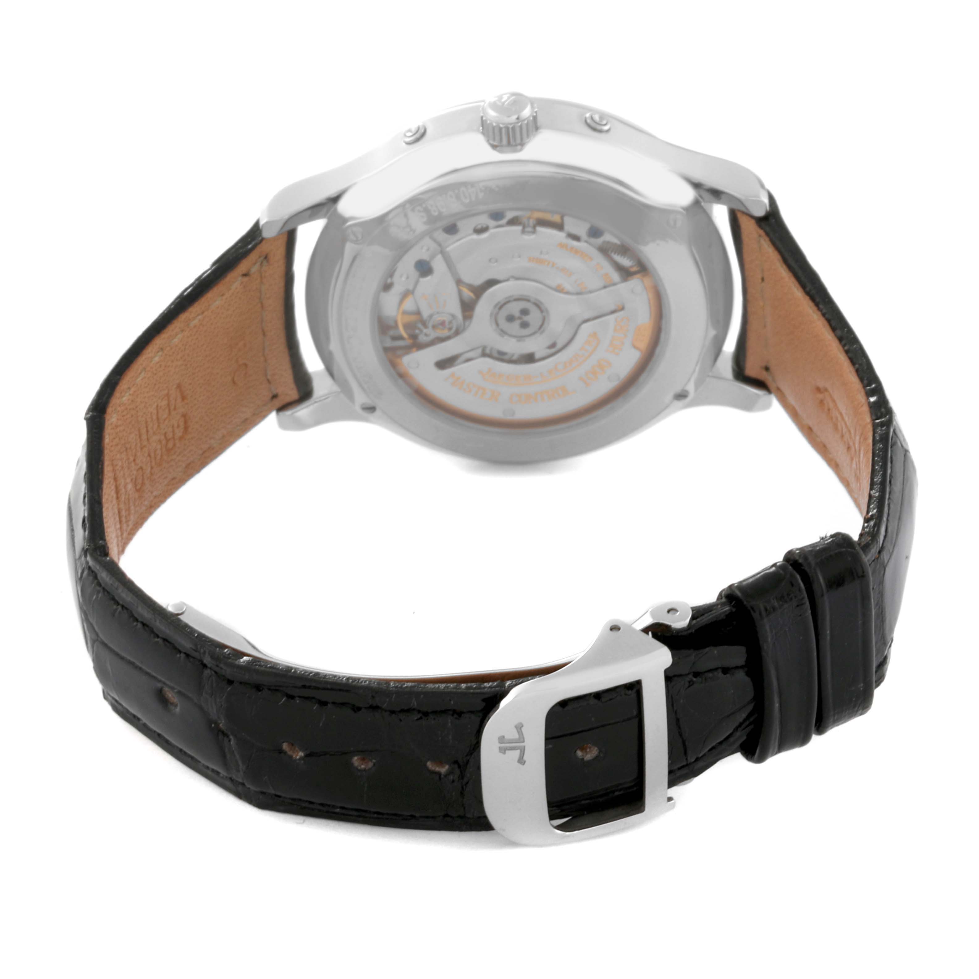 The image shows the back view of a Jaeger-LeCoultre Master model watch, displaying the movement mechanism and leather strap.