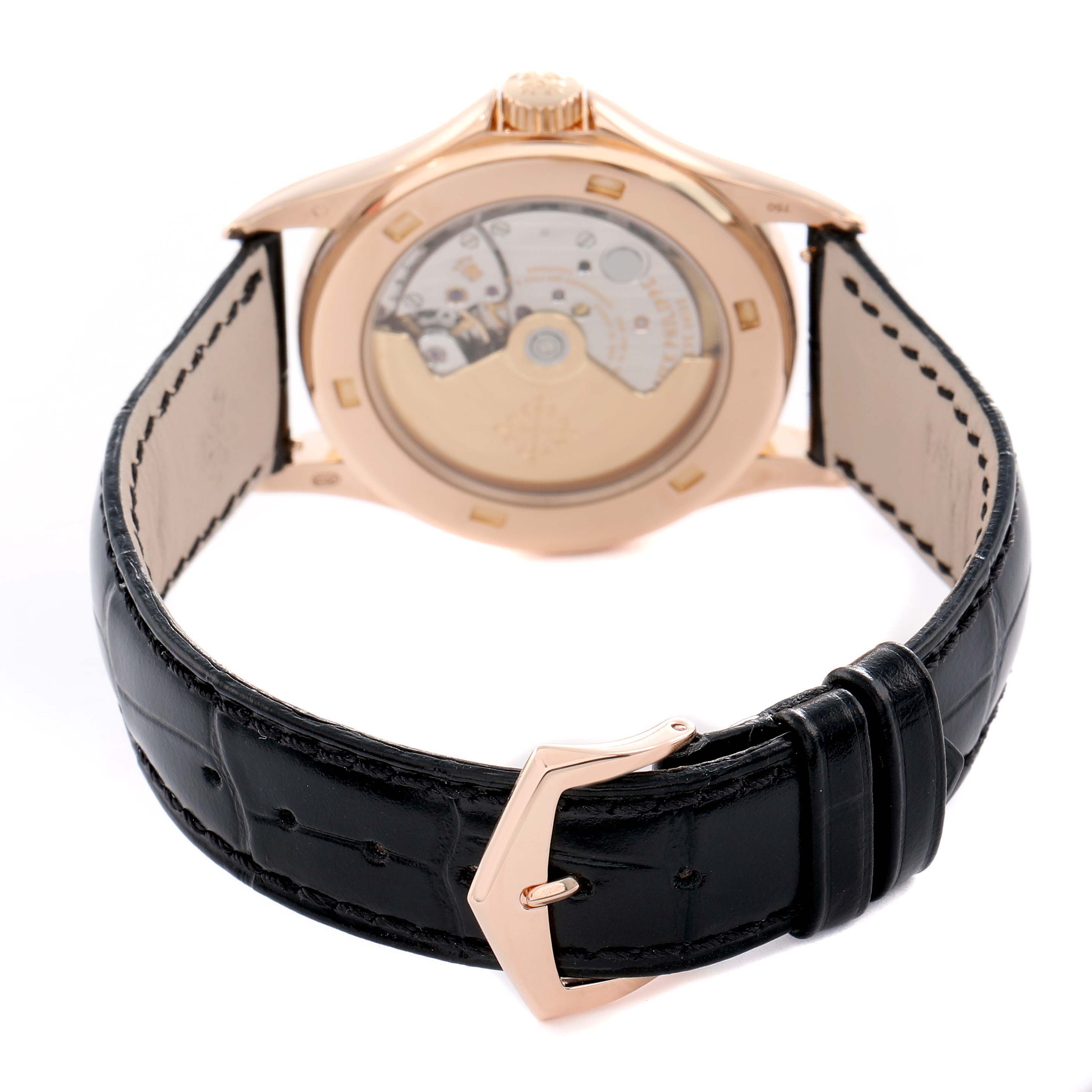 The image shows the back view of a Patek Philippe Calatrava 5127R Men
s Rose Gold Silver Dial, highlighting its transparent case back, crown, and black leather strap.