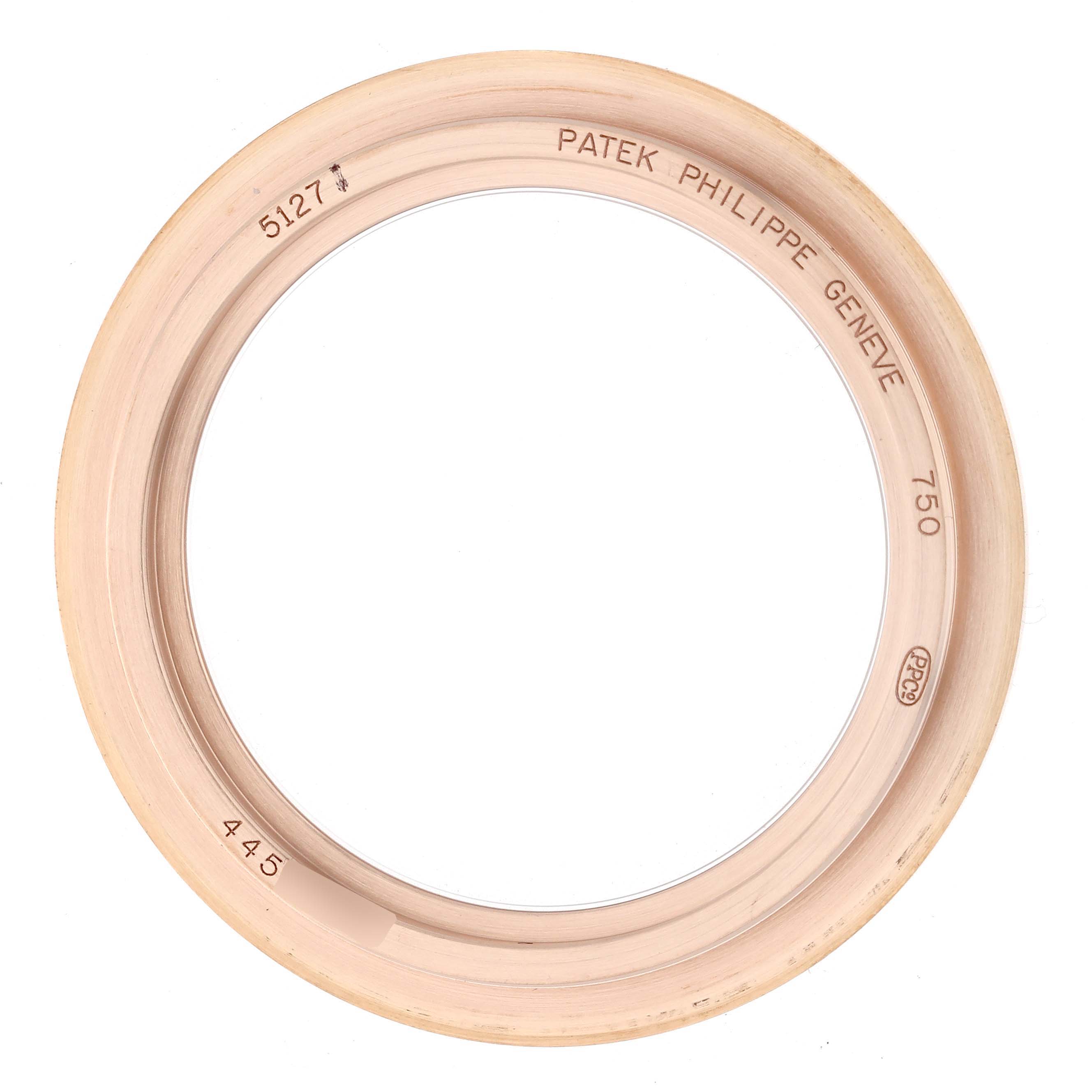 The image shows a bezel from a Patek Philippe Calatrava 5127R Men
s Rose Gold Silver Dial watch, viewed from above, displaying engravings and classifications.