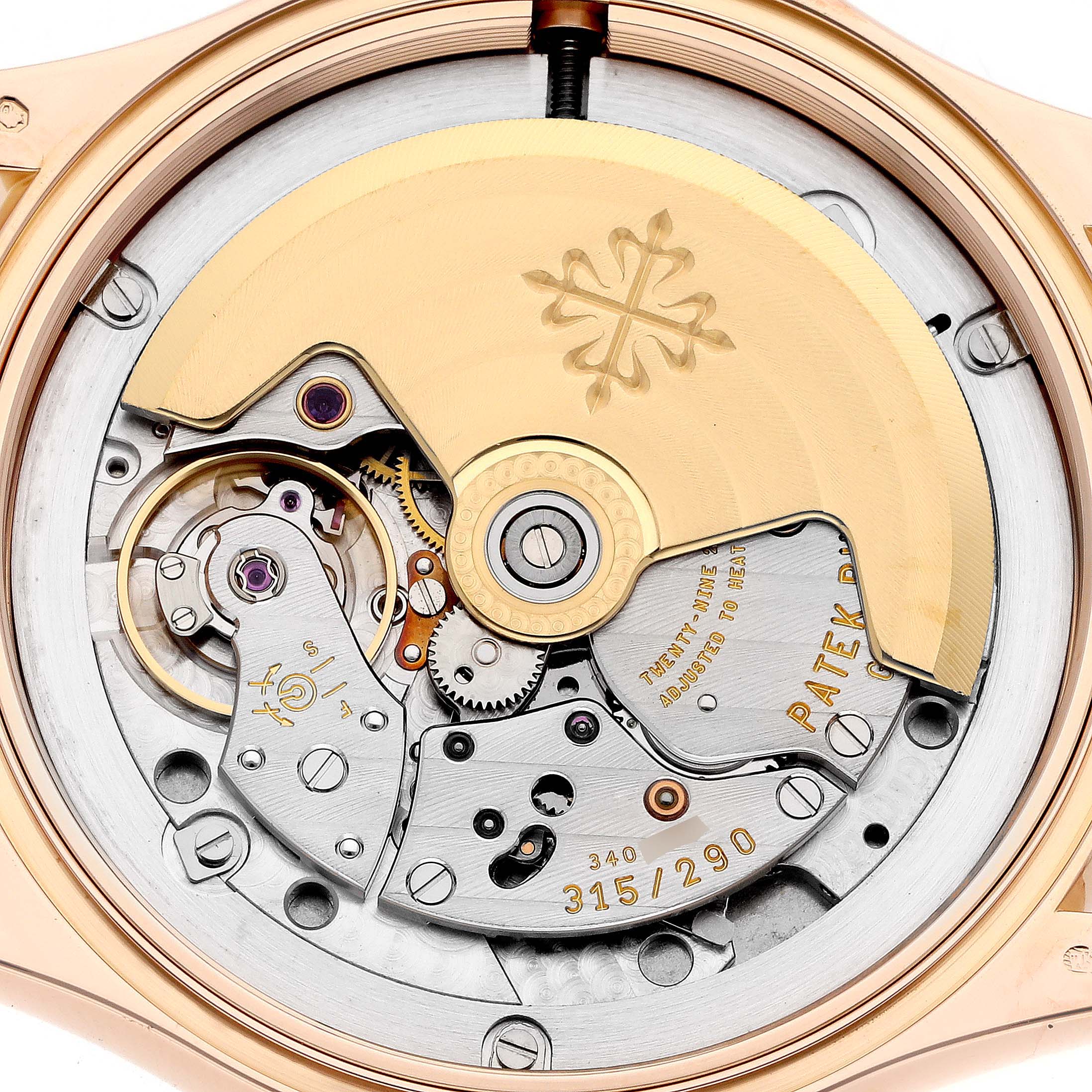 This image shows the movement of a Patek Philippe Calatrava 5127R Men
s Rose Gold Silver Dial watch from the back, highlighting the rotor and mechanical components.