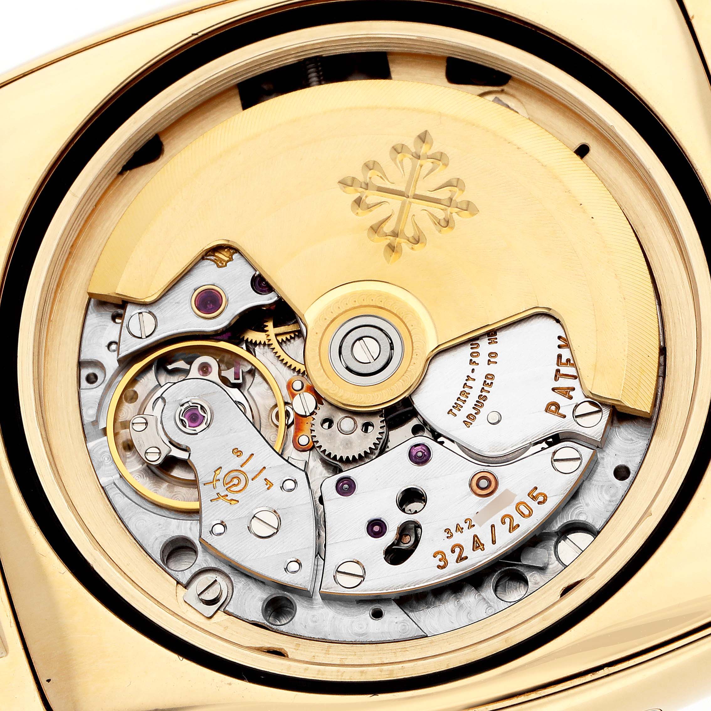 The image shows the back view of a Patek Philippe Gondolo 5135J Men
s Yellow Gold White Dial watch, highlighting its intricate movement and rotor.