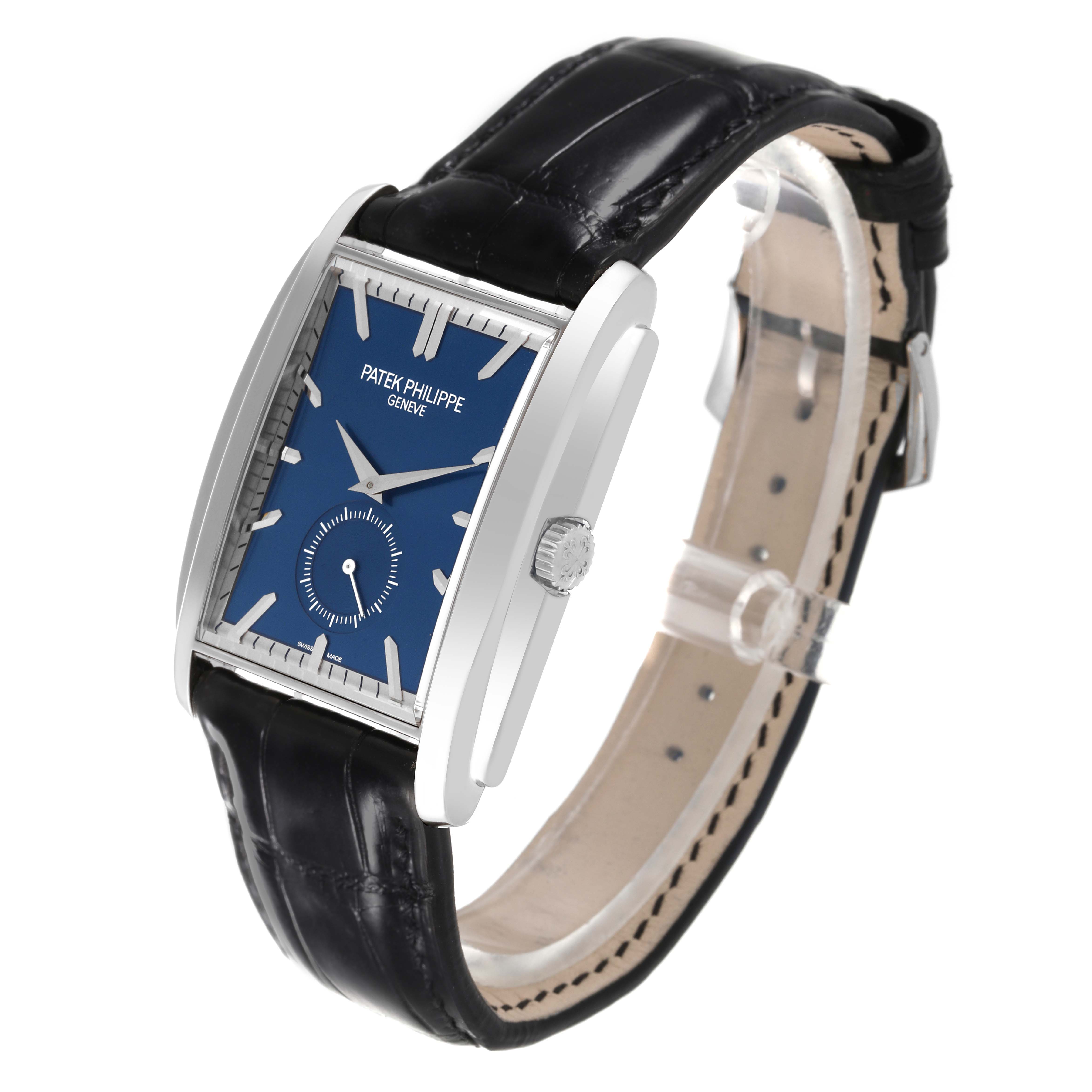 The image shows a three-quarter view of the Patek Philippe Gondolo 5124G-011 Men's White Gold Blue Dial 5124G-011 Men's White Gold Blue Dial watch, highlighting its rectangular blue dial and black leather strap.