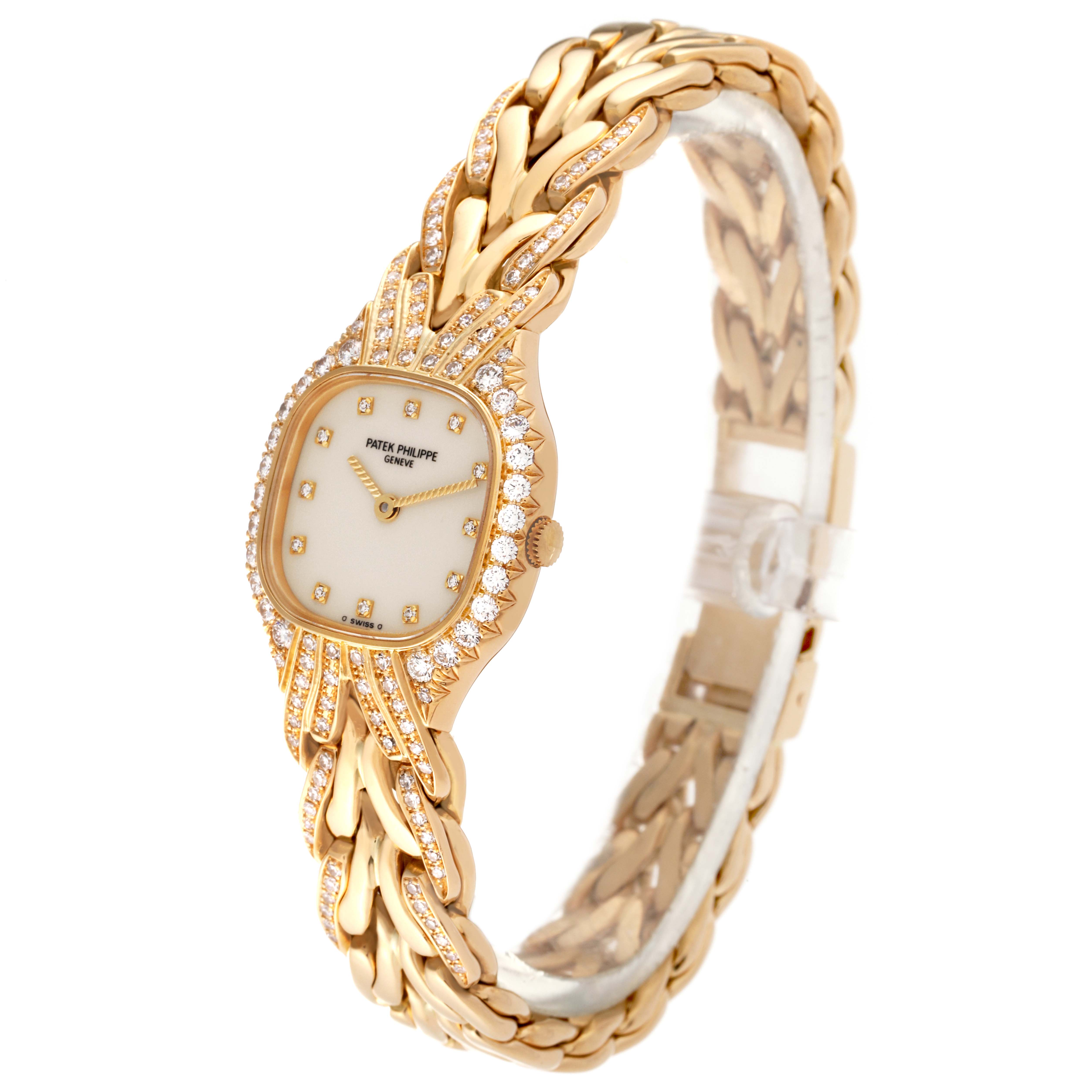 The image shows a Patek Philippe La Flamme  4815/003 Women's Yellow Gold Silver Dial 4815/003 Women's Yellow Gold Silver Dialwatch at a three-quarter angle, highlighting the diamond-studded bezel and gold bracelet.