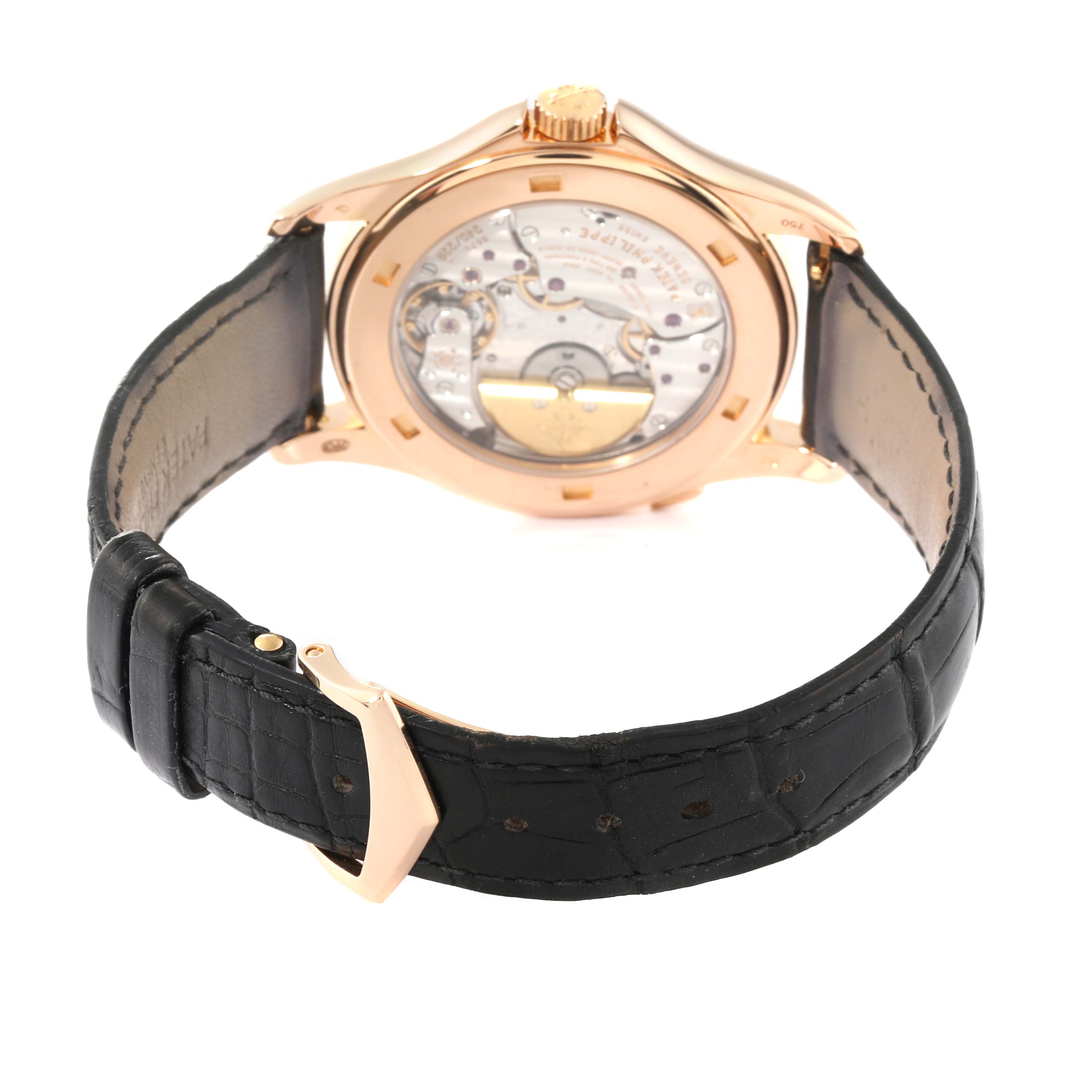 The image shows the back view of a Patek Philippe Complications 5130R-001 Men's Rose Gold Silver Dial 5130R-001 Men's Rose Gold Silver Dial watch, focusing on the exposed mechanical movement and the leather strap.