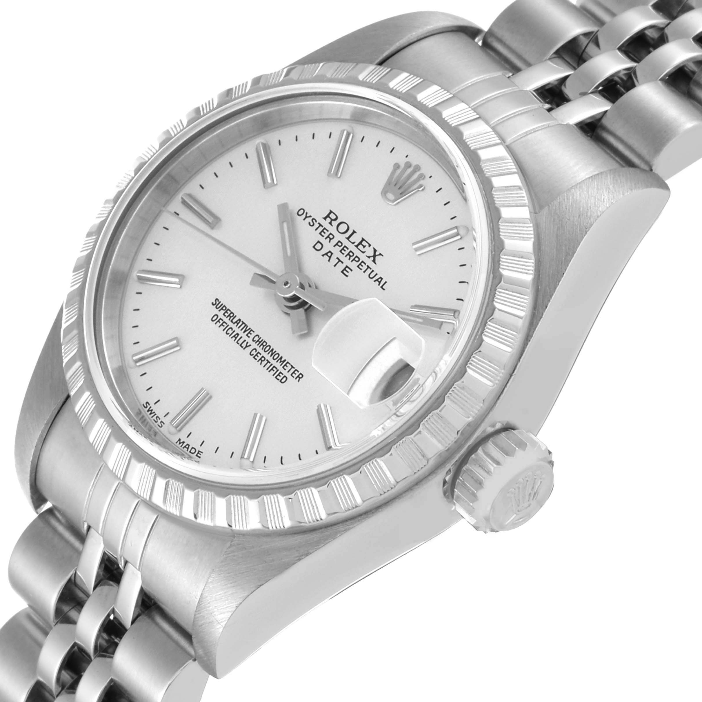 The image shows a close-up of the Rolex Oyster Perpetual Date watch, highlighting the dial, bezel, crown, and part of the bracelet.