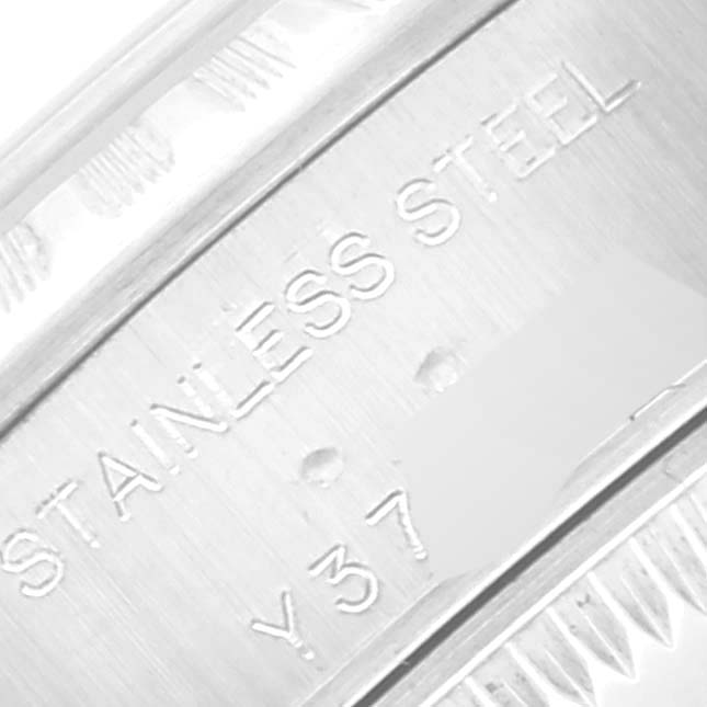 This close-up image shows the side of a Rolex Date 79240 Women
s Stainless Steel Silver Dial 79240 Women
s Stainless Steel Silver Dial model watch, focusing on the engraved "STAINLESS STEEL" marking.