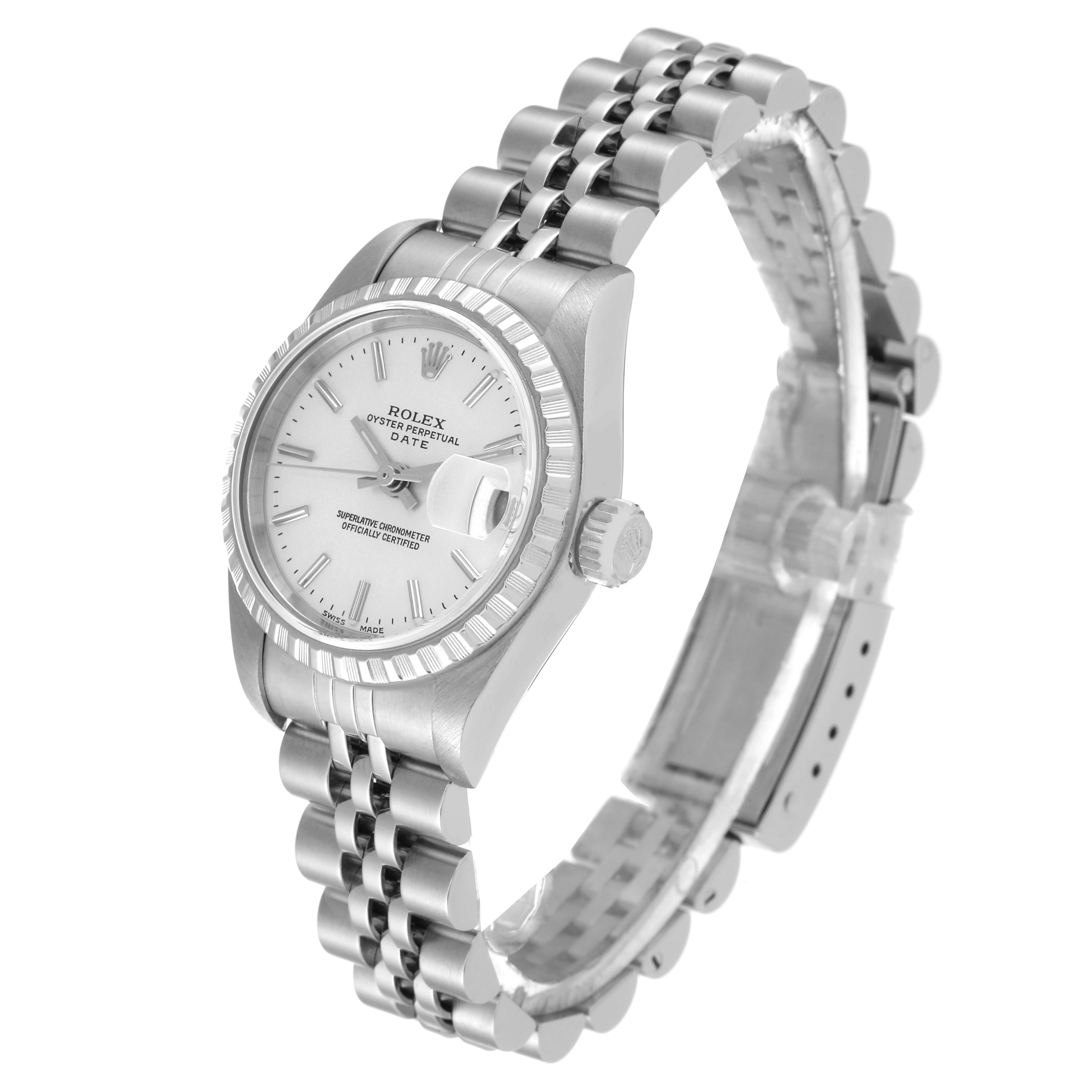 The image shows a Rolex Oyster Perpetual Date watch at an angle highlighting the face, bezel, crown, and bracelet.