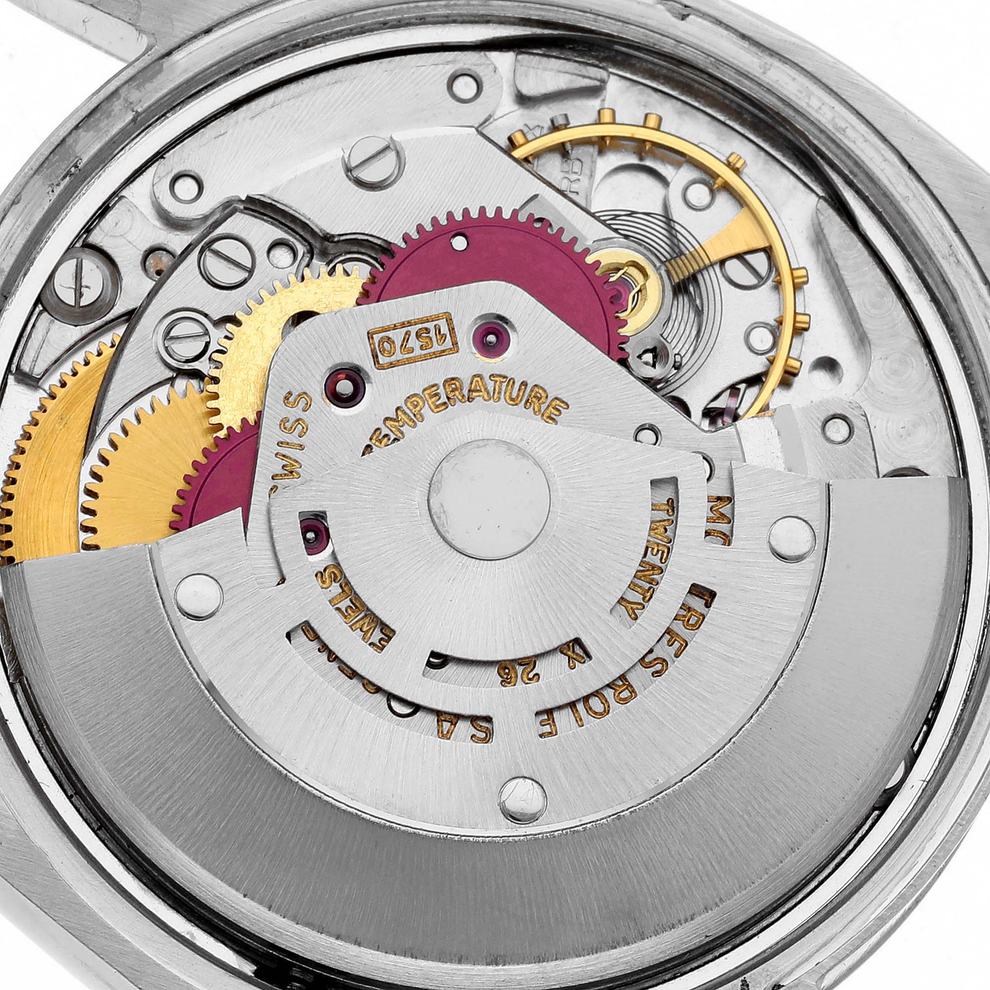 The image shows a close-up of the internal mechanism of a Vintage Collection Rolex, highlighting gears and the intricate movement parts.