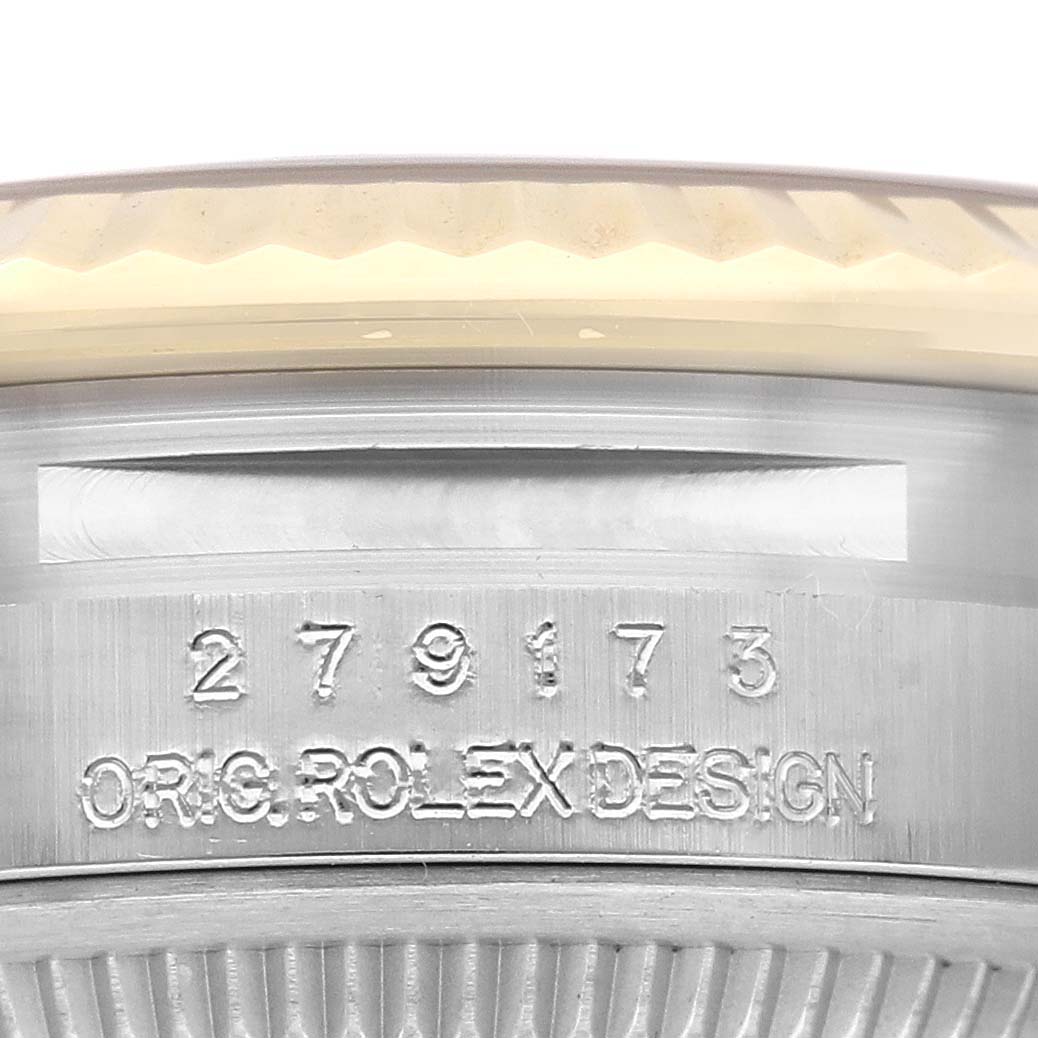 This image shows a close-up of the side of a Rolex Datejust 279173 Women's Steel and Gold (two tone) Champagne Dial 279173 Women's Steel and Gold (two tone) Champagne Dial watch case, featuring the serial number and "ORIG ROLEX DESIGN" engraving.