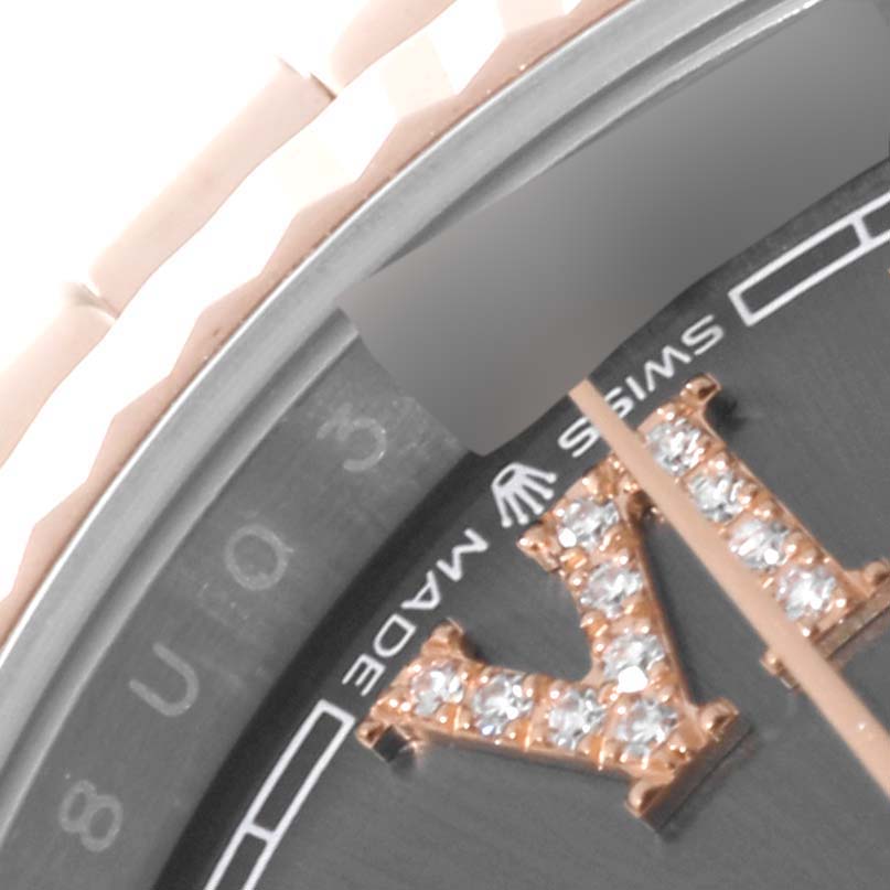 The image shows a close-up of the dial, fluted bezel, and part of the bracelet of a Rolex Datejust 126231 Men's Steel and Gold (two tone) Grey Dial 126231 Men's Steel and Gold (two tone) Grey Dial watch with a diamond-encrusted Roman numeral and "Swiss Made" text.