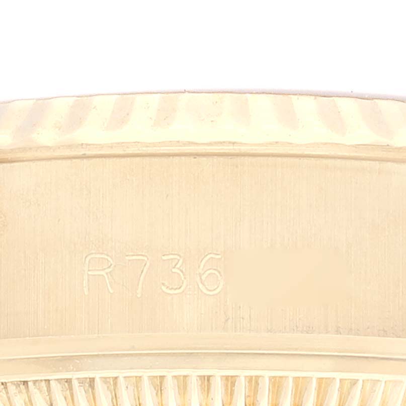 This image shows a close-up of the side engraving of a Rolex President 69178 Women's Yellow Gold Champagne Dial 69178 Women's Yellow Gold Champagne Dial model watch bezel.