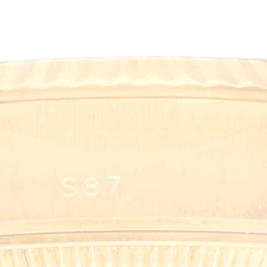 This close-up image shows the hallmark and fluted bezel of a Rolex President 69178 Women
s Yellow Gold Champagne Dial 69178 Women
s Yellow Gold Champagne Dial model watch.